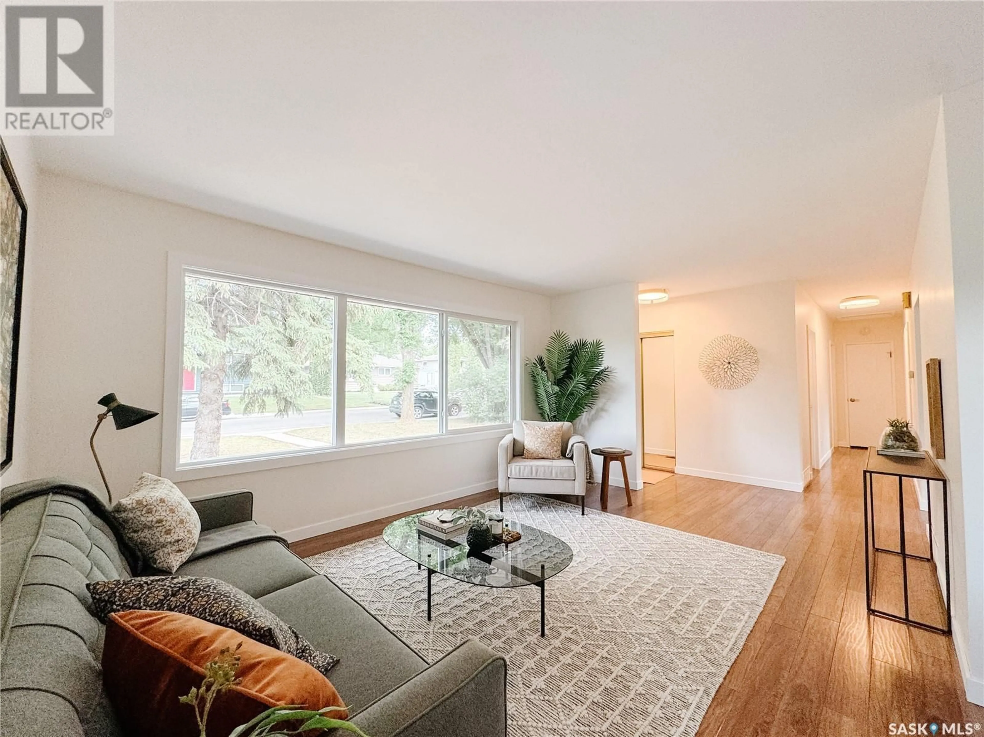 Living room with furniture, wood/laminate floor for 49 RUTTER CRESCENT, Saskatoon Saskatchewan S7H3B6