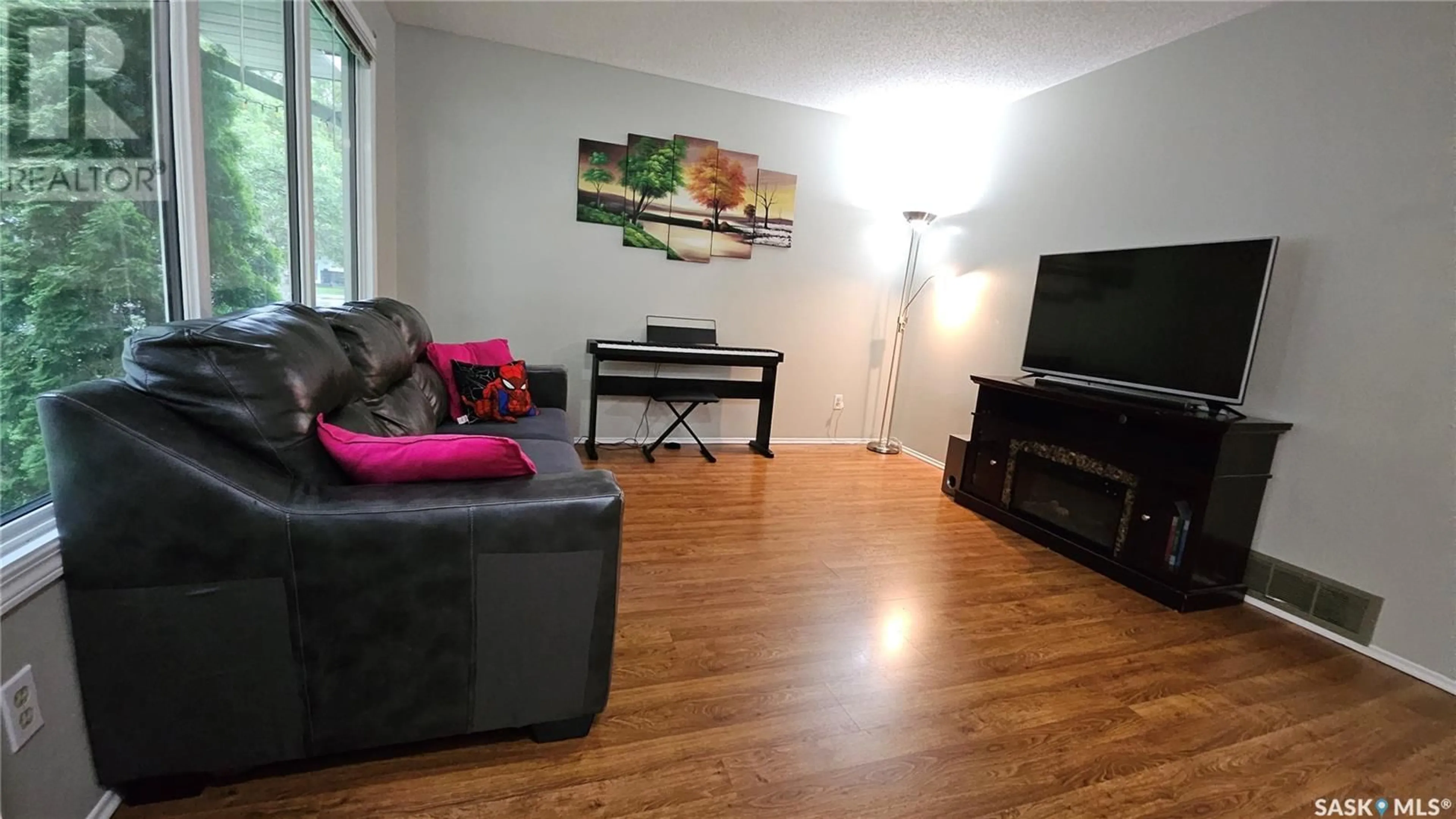 Living room with furniture, wood/laminate floor for 75 WALTER CRESCENT, Regina Saskatchewan S4X1L5