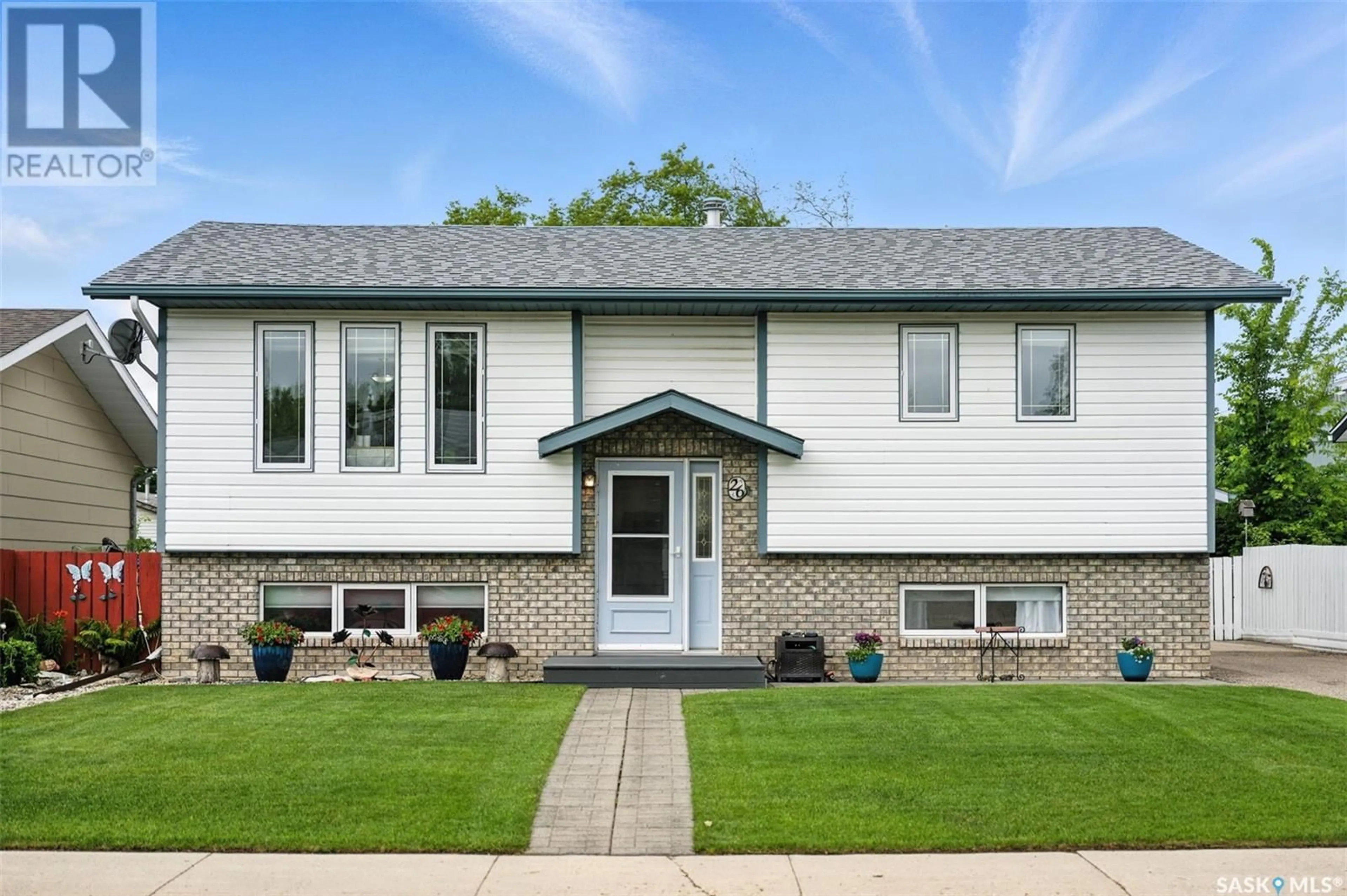 Home with vinyl exterior material, street for 26 HOWARD CRESCENT, Lanigan Saskatchewan S0K2M0