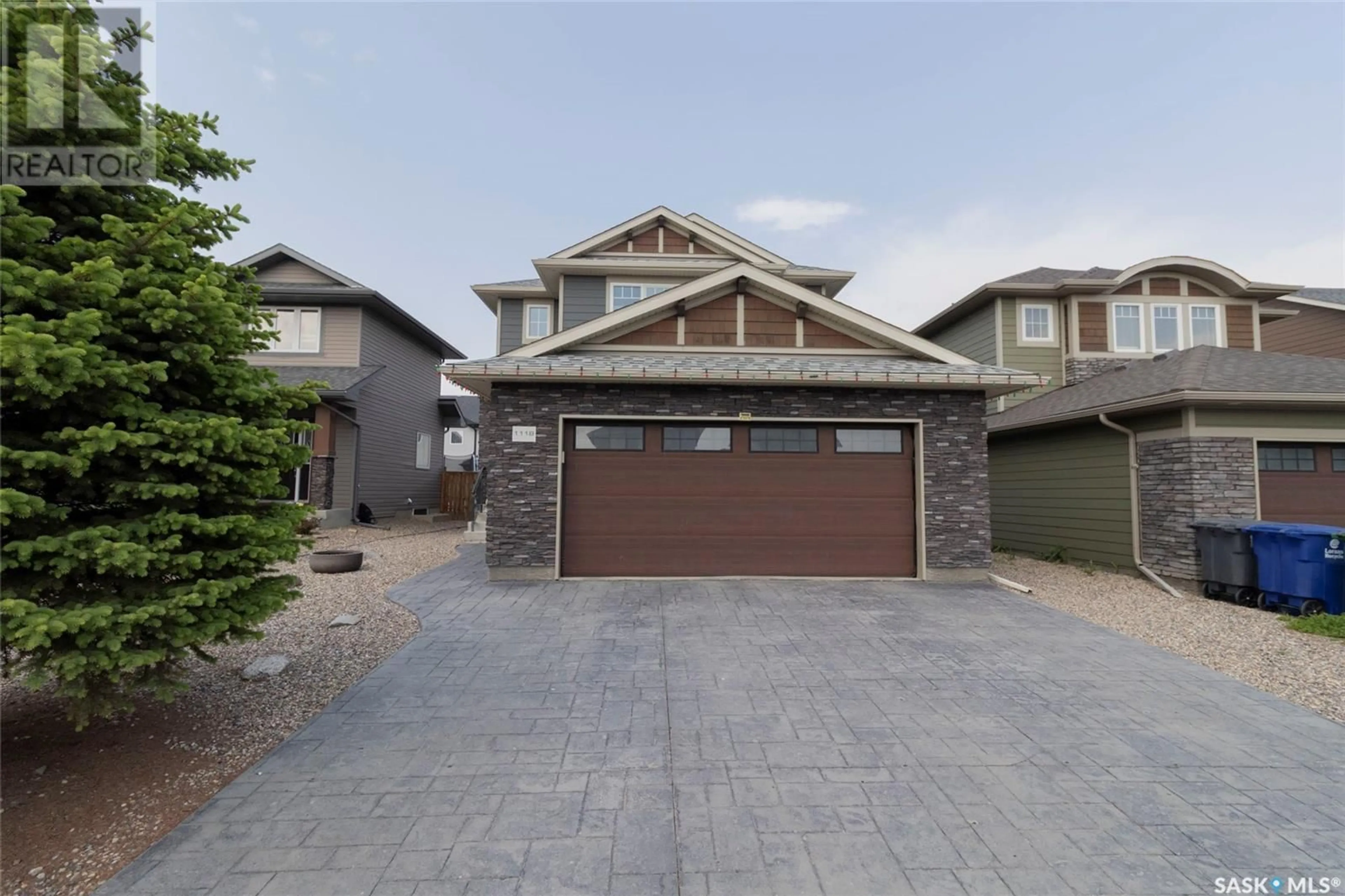 Home with vinyl exterior material, street for 1118 DENHAM RISE, Saskatoon Saskatchewan S7R0B2