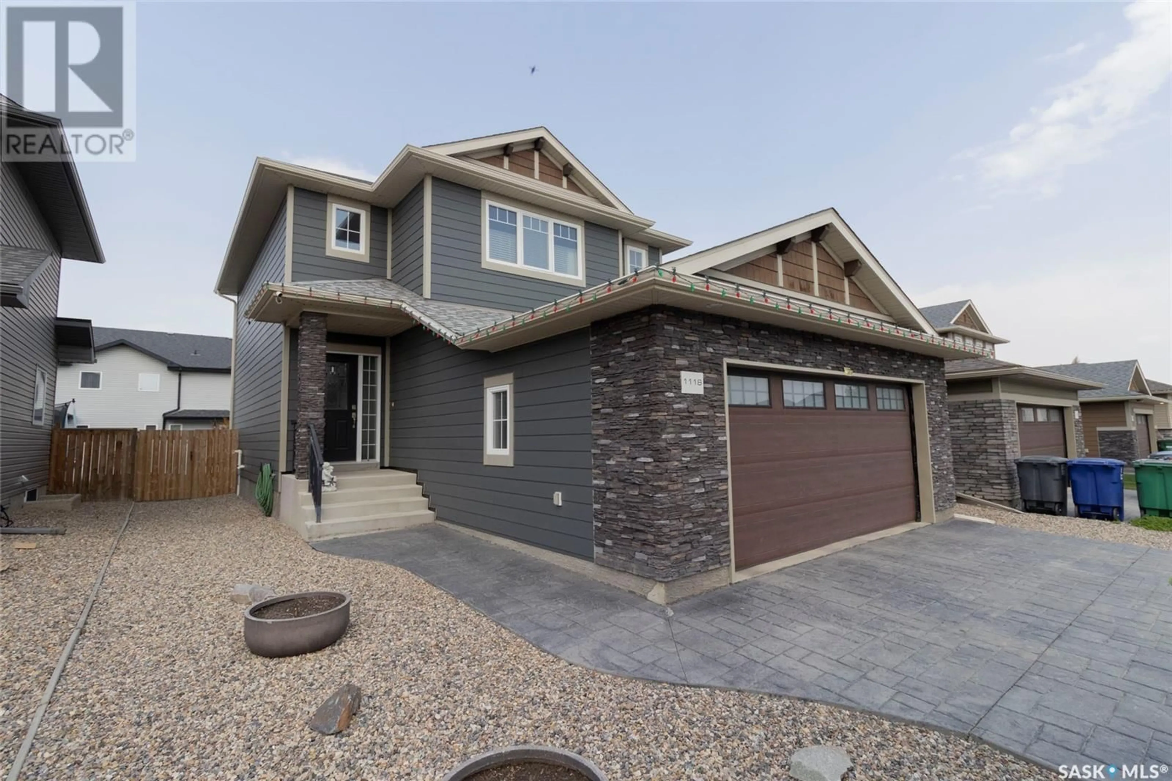 Home with vinyl exterior material, street for 1118 DENHAM RISE, Saskatoon Saskatchewan S7R0B2