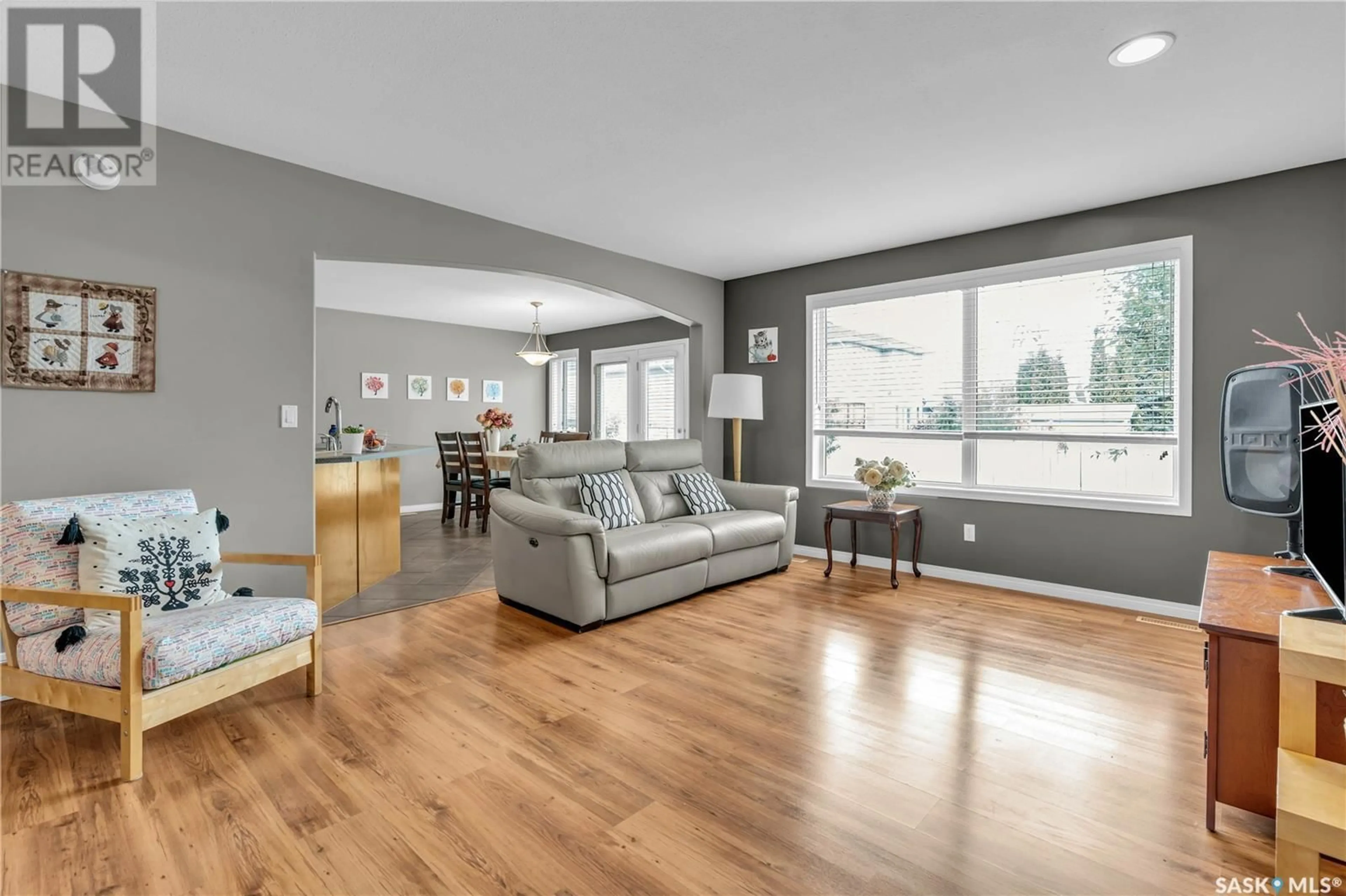 Living room with furniture, wood/laminate floor for 715 BUCKWOLD COVE, Saskatoon Saskatchewan S7N4V8