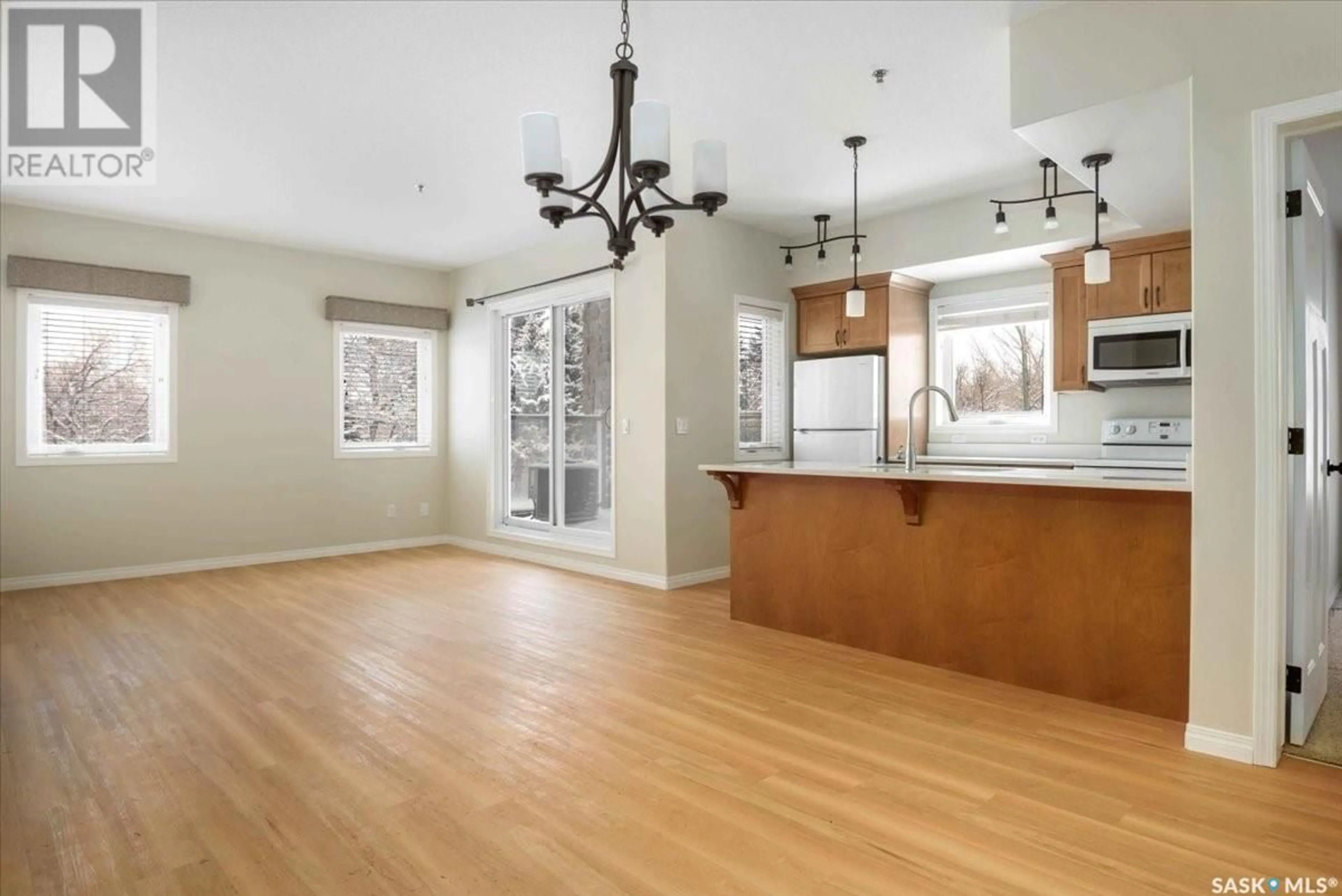 Open concept kitchen, wood/laminate floor for 1220 - 115 BLACKFOOT DRIVE, Regina Saskatchewan S4S6T2