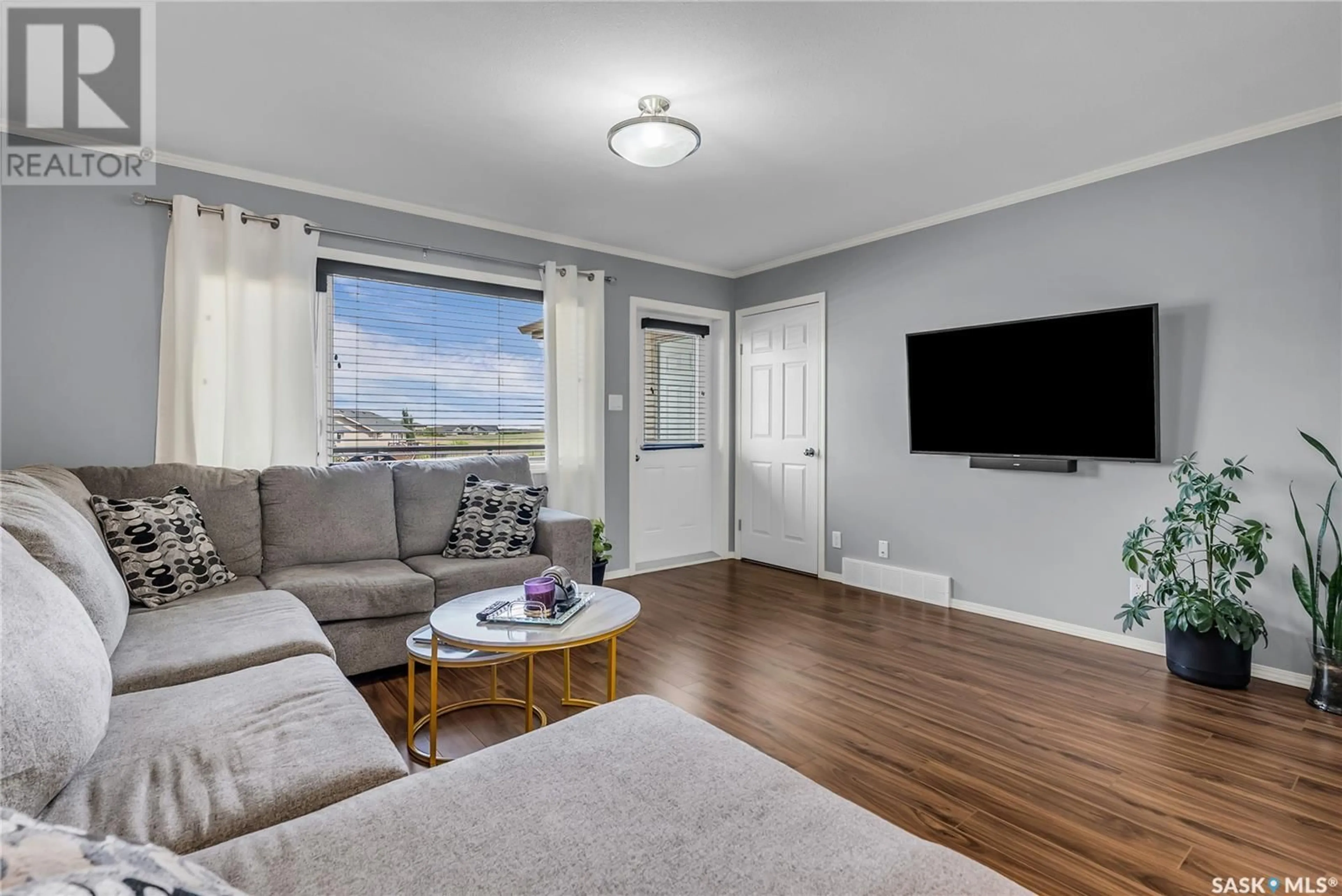 Living room with furniture, wood/laminate floor for 310 - 1303 RICHARDSON ROAD, Saskatoon Saskatchewan S7R0L1