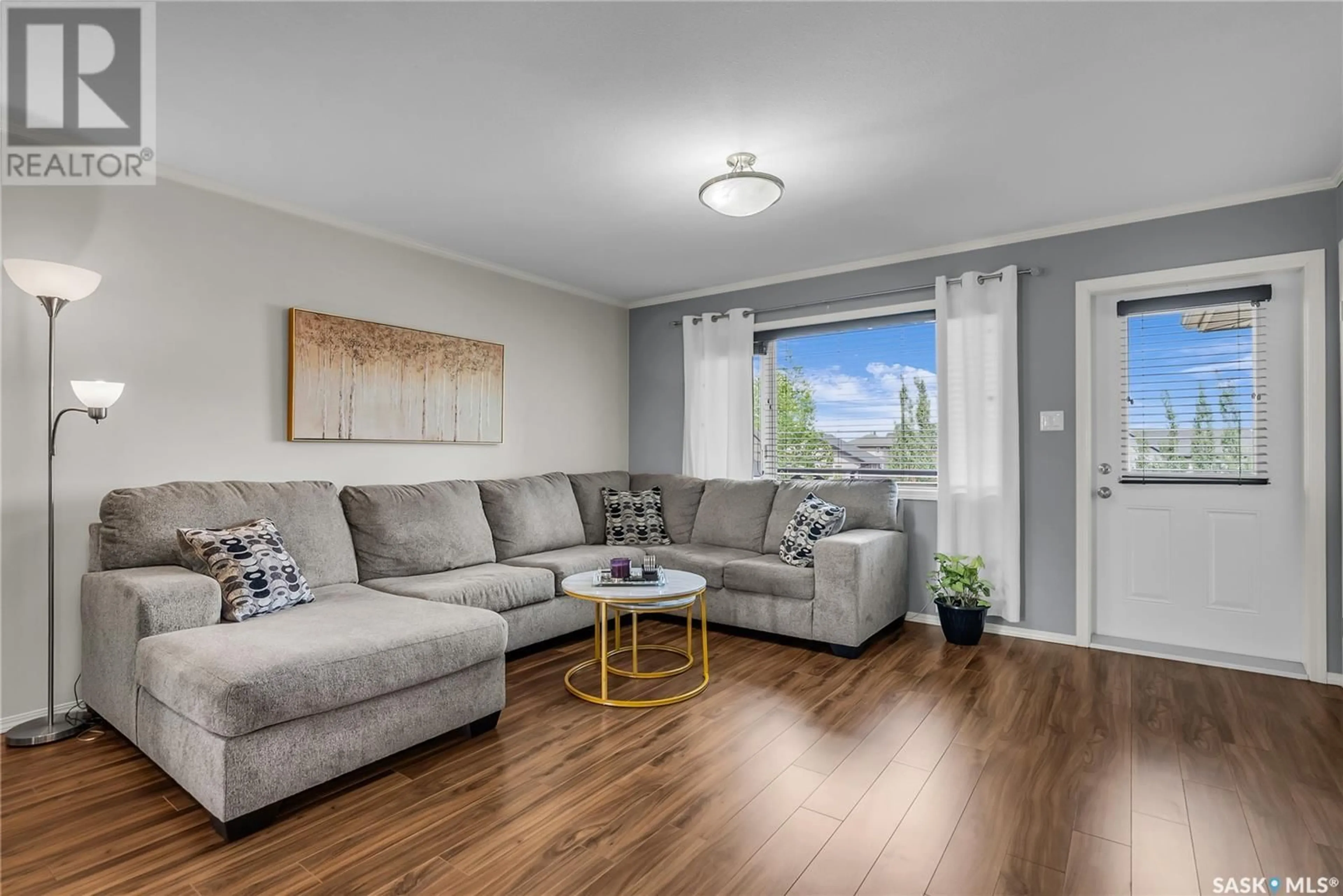 Living room with furniture, wood/laminate floor for 310 - 1303 RICHARDSON ROAD, Saskatoon Saskatchewan S7R0L1