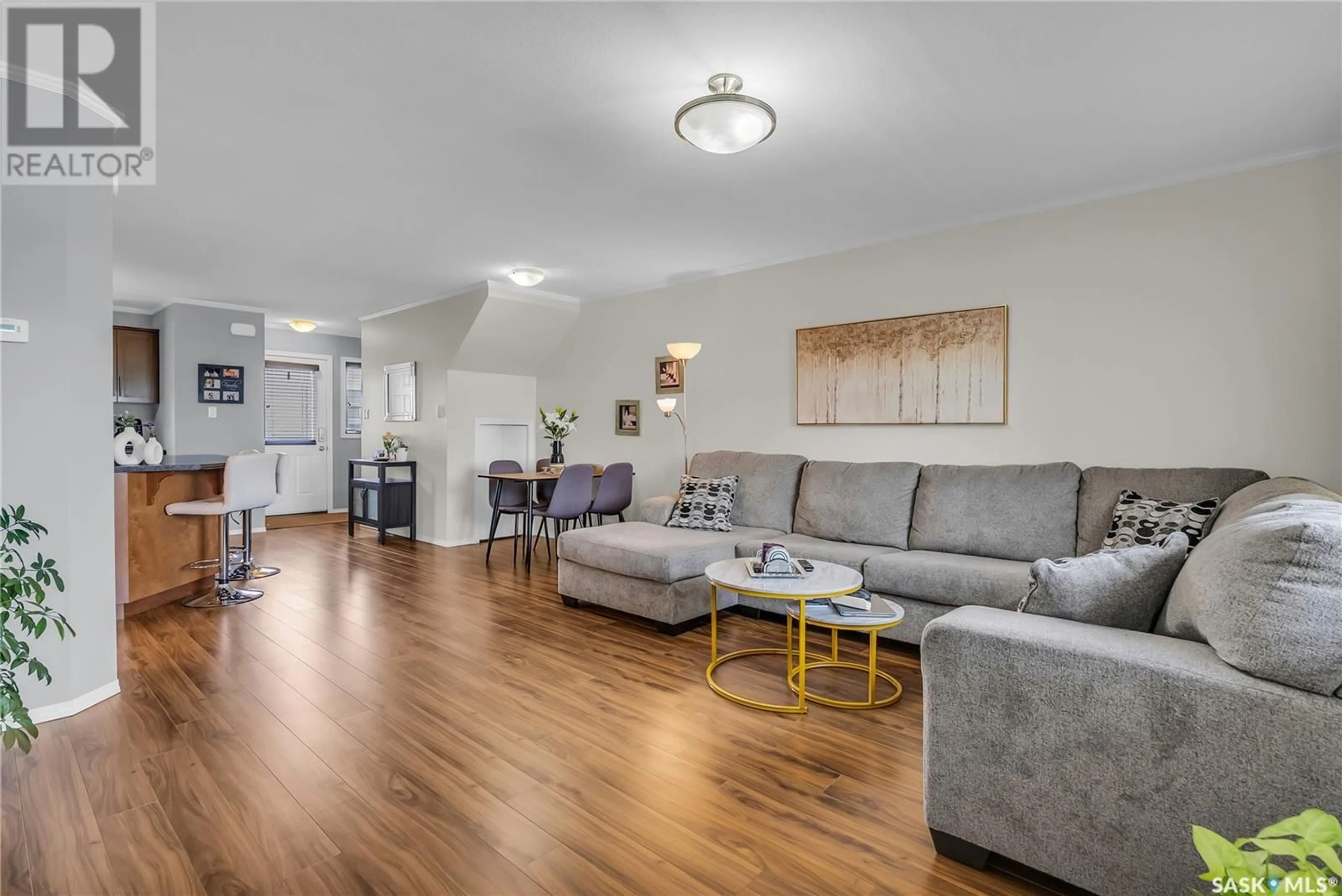 Living room with furniture, wood/laminate floor for 310 - 1303 RICHARDSON ROAD, Saskatoon Saskatchewan S7R0L1