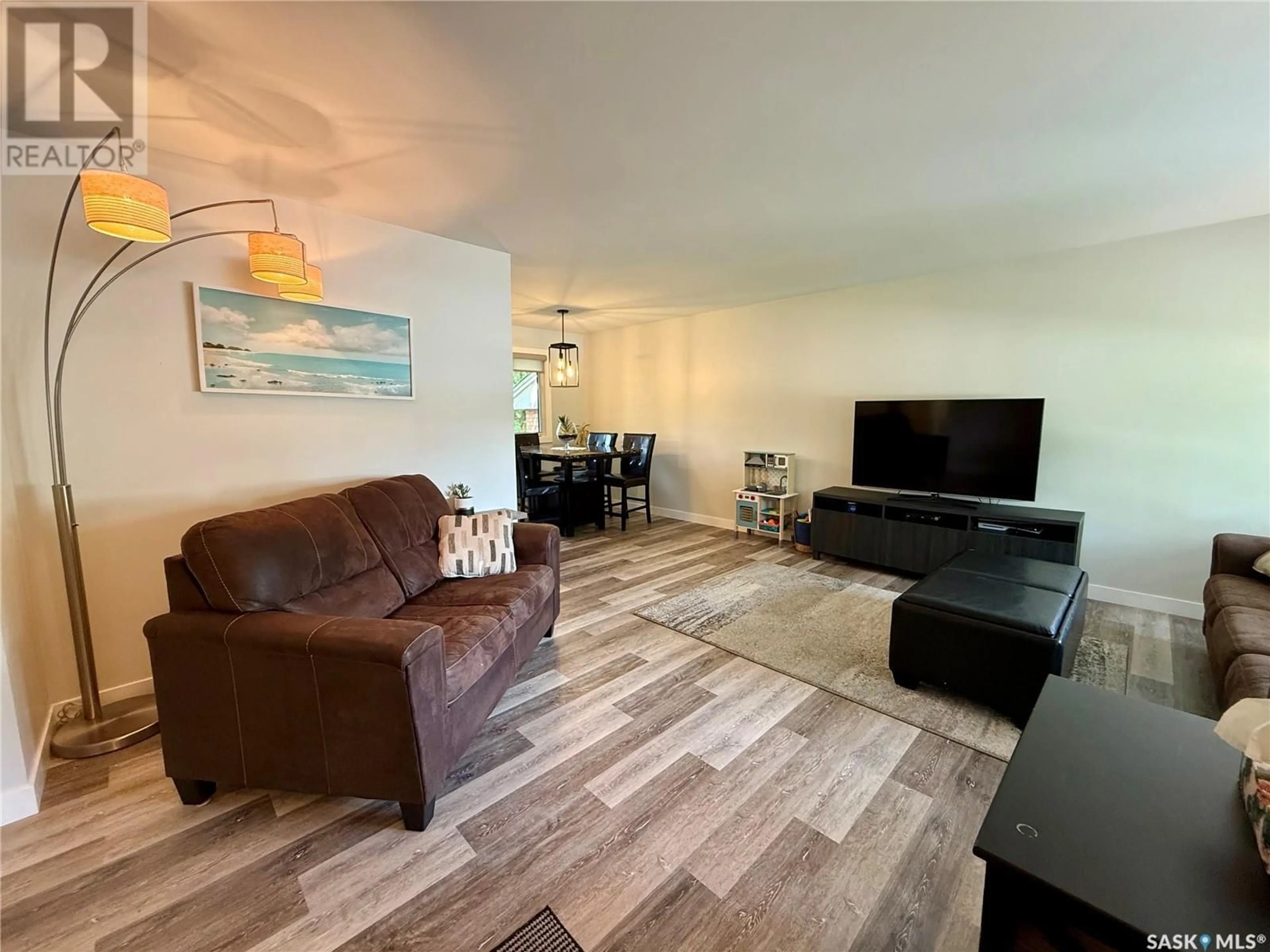 Living room with furniture, wood/laminate floor for 213 DUNCAN ROAD, Estevan Saskatchewan S4A0A3