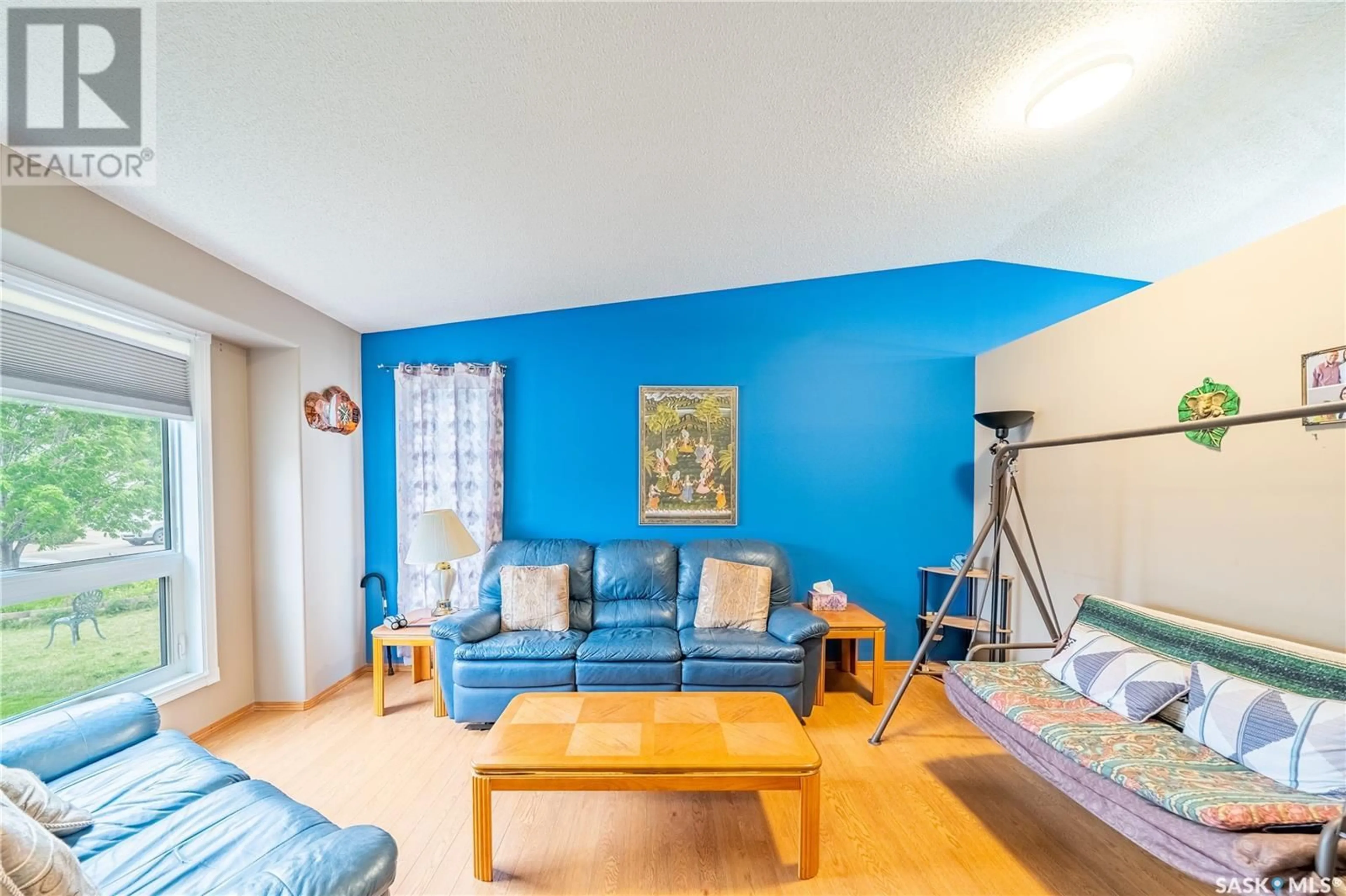 Living room with furniture, wood/laminate floor for 5256 STAFF CRESCENT, Regina Saskatchewan S4X4M2