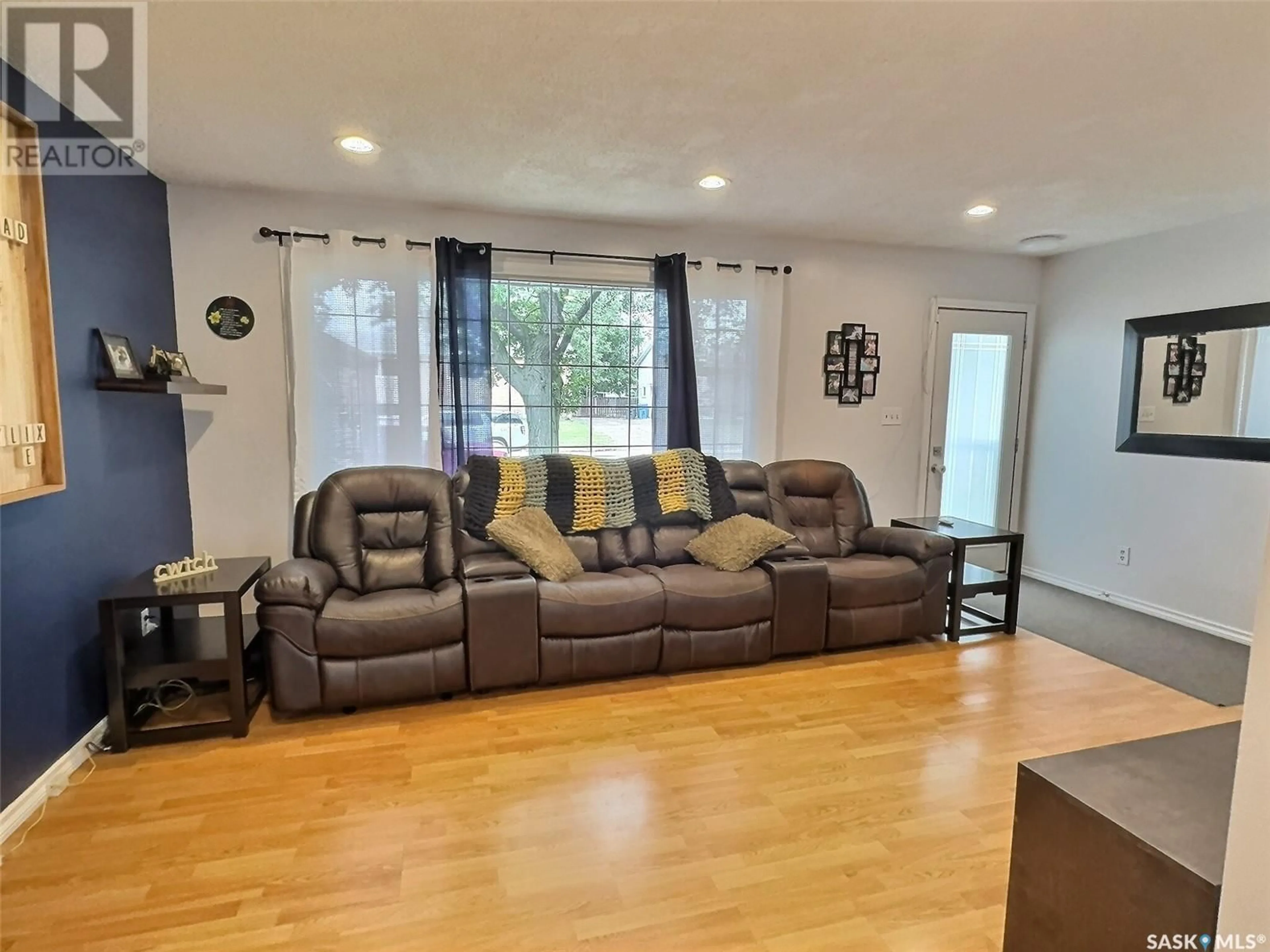 Living room with furniture, wood/laminate floor for 713 ALBERT STREET, Estevan Saskatchewan S4A1R7