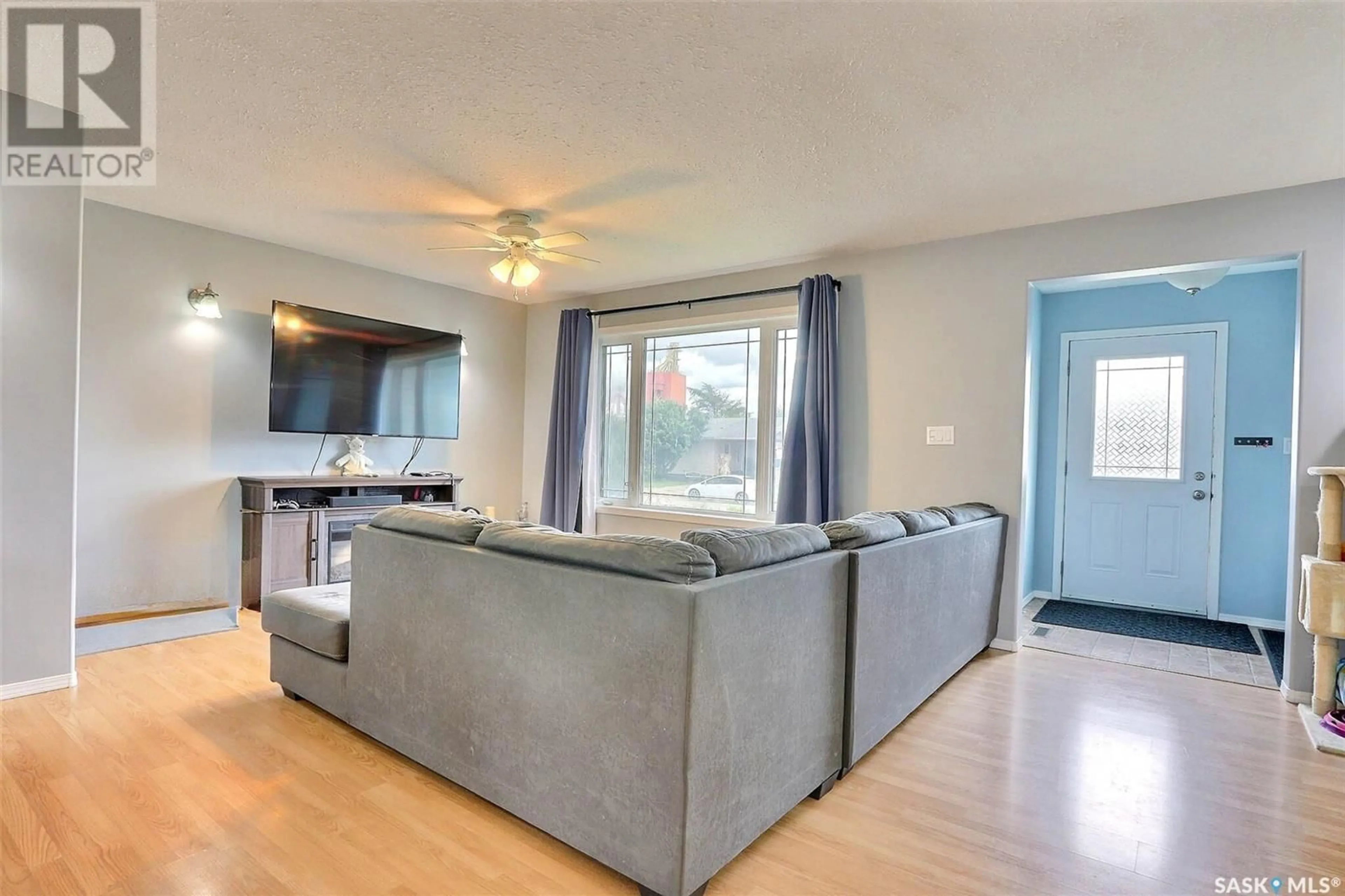 Living room with furniture, wood/laminate floor for 104 1ST AVENUE, Shellbrook Saskatchewan S0J0N0