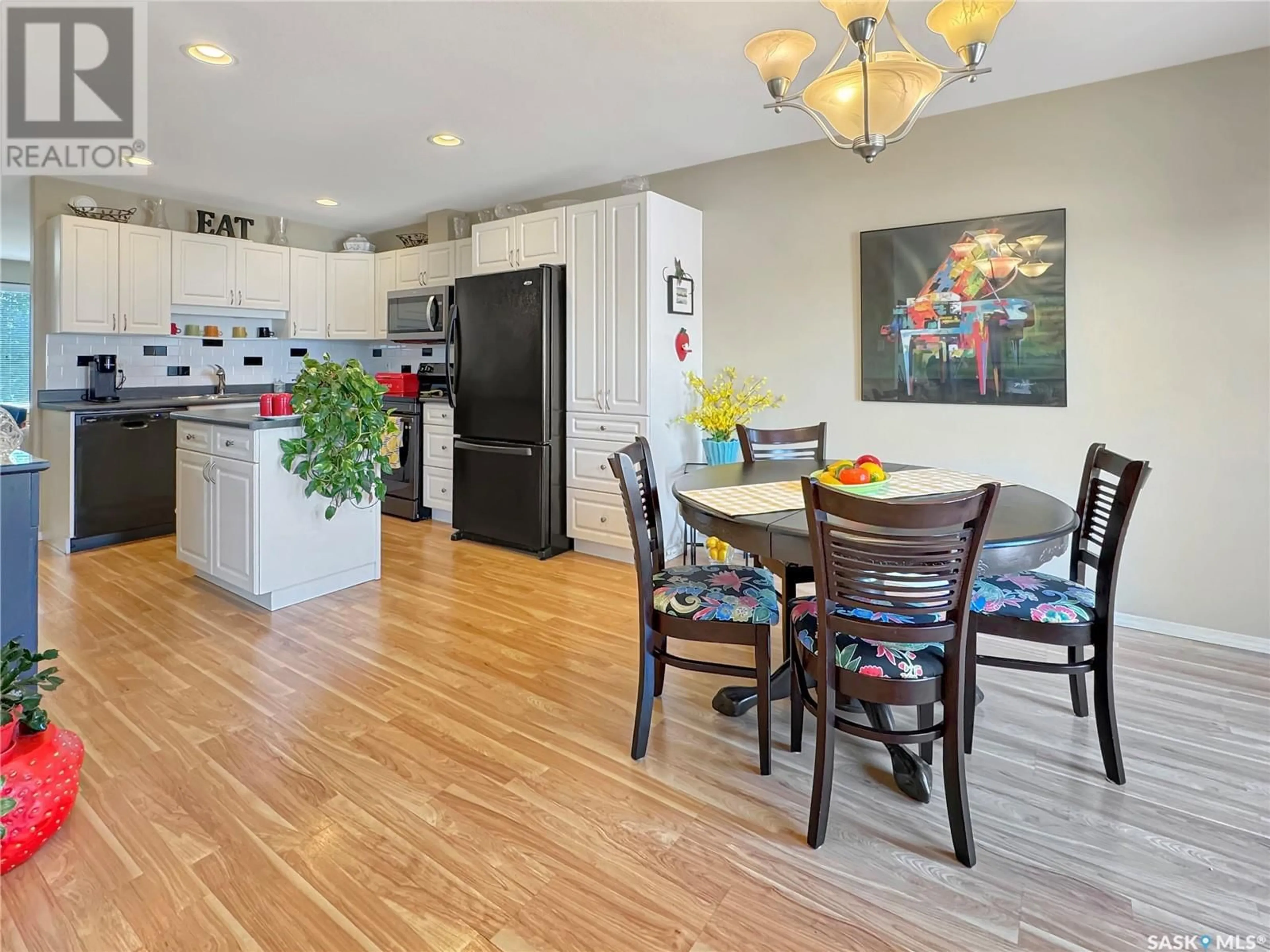 Open concept kitchen, wood/laminate floor for C - 10901 AMOS DRIVE, North Battleford Saskatchewan S9A0S6