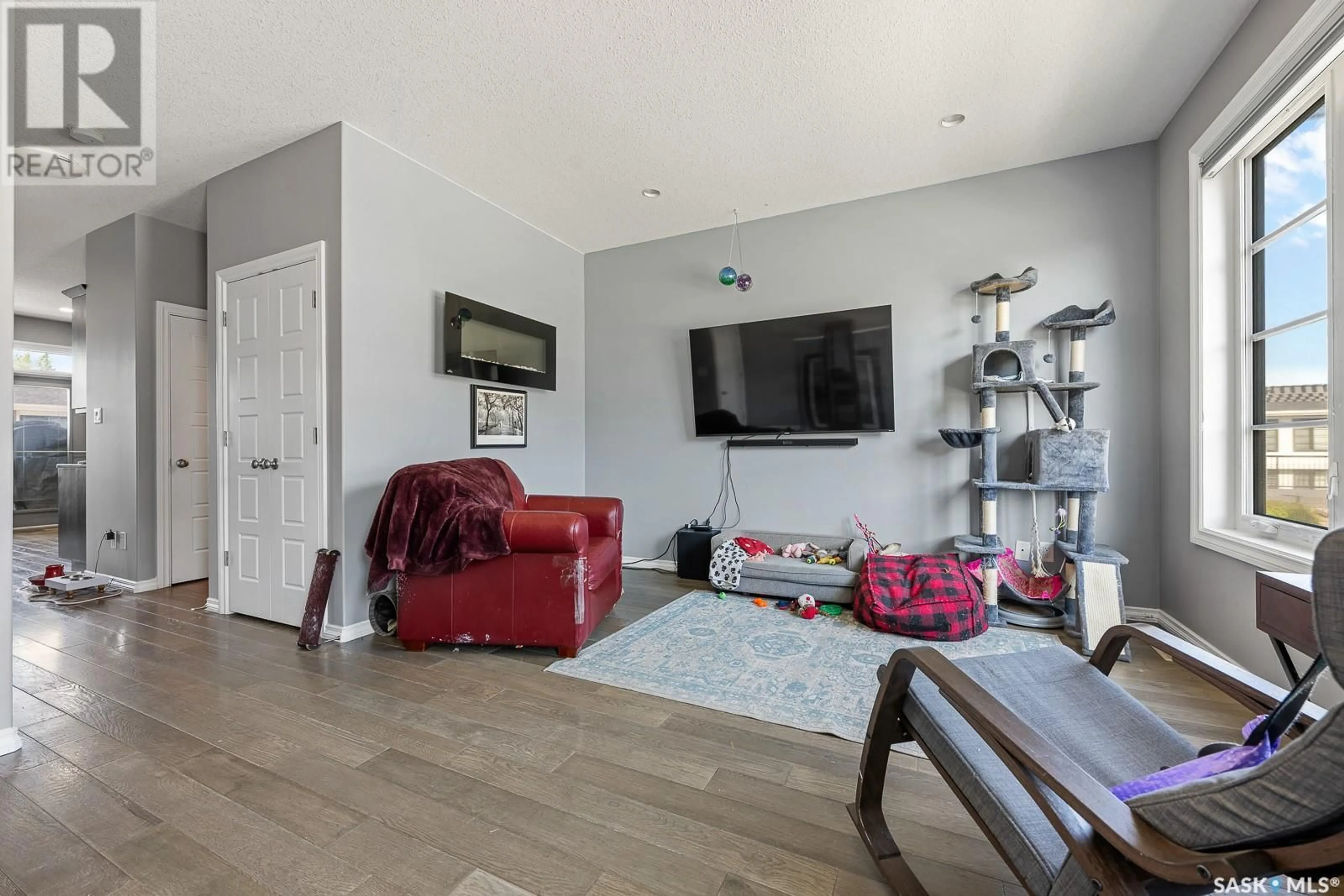 Living room with furniture, wood/laminate floor for 216 - 3229 ELGAARD DRIVE, Regina Saskatchewan S4X0L2