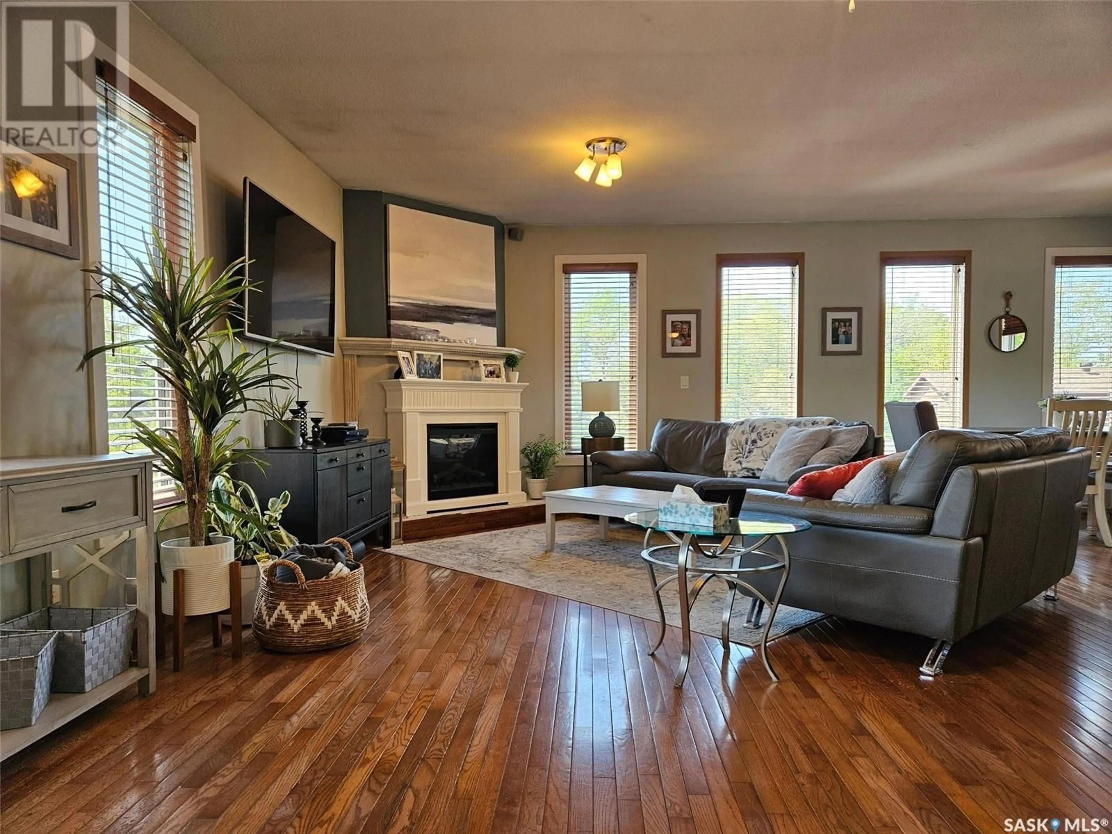 Living room with furniture, wood/laminate floor for 12 ALICE CRESCENT, Dufferin Rm No. 190 Saskatchewan S0H4C0