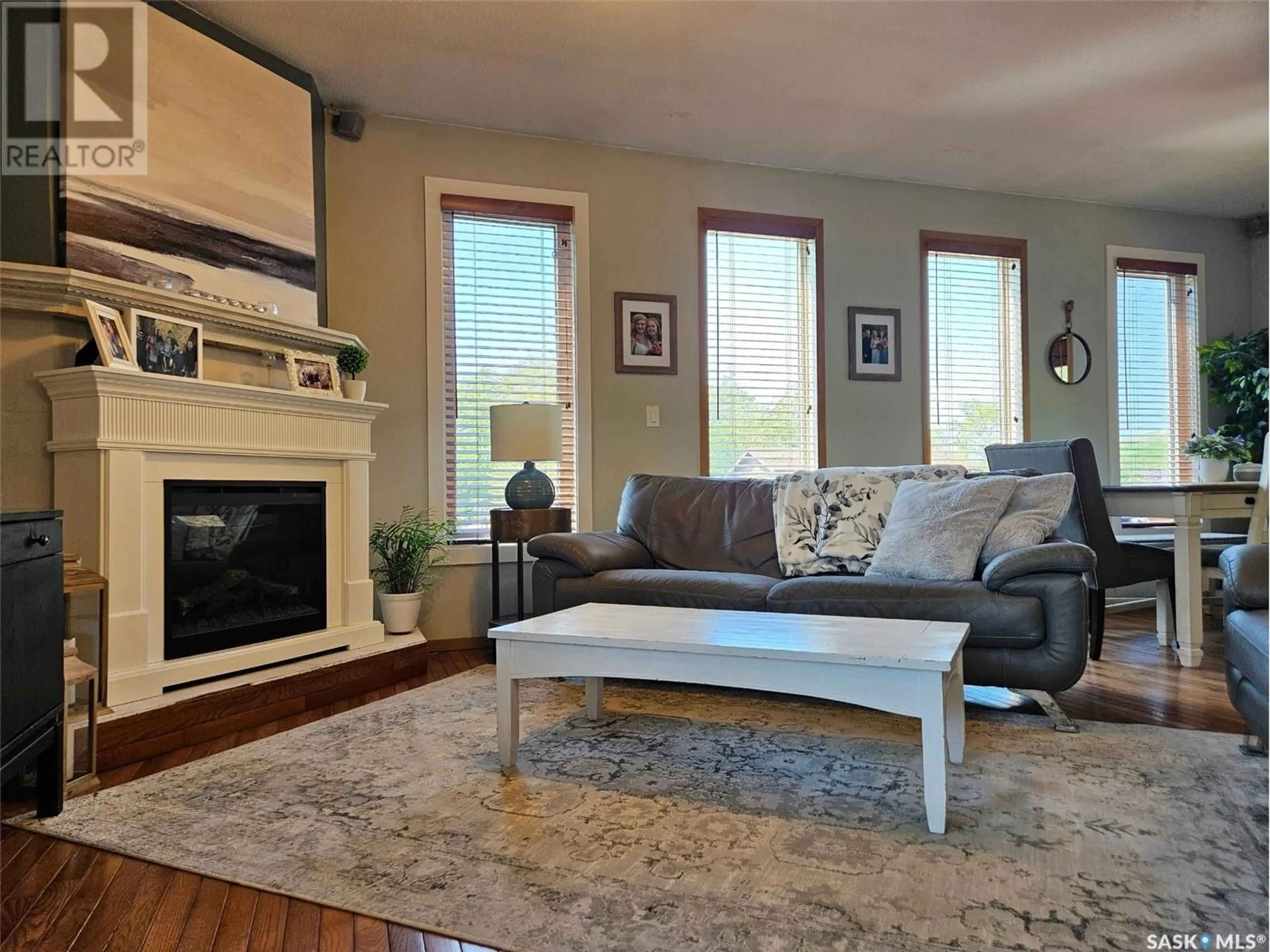 Living room with furniture, wood/laminate floor for 12 ALICE CRESCENT, Dufferin Rm No. 190 Saskatchewan S0H4C0