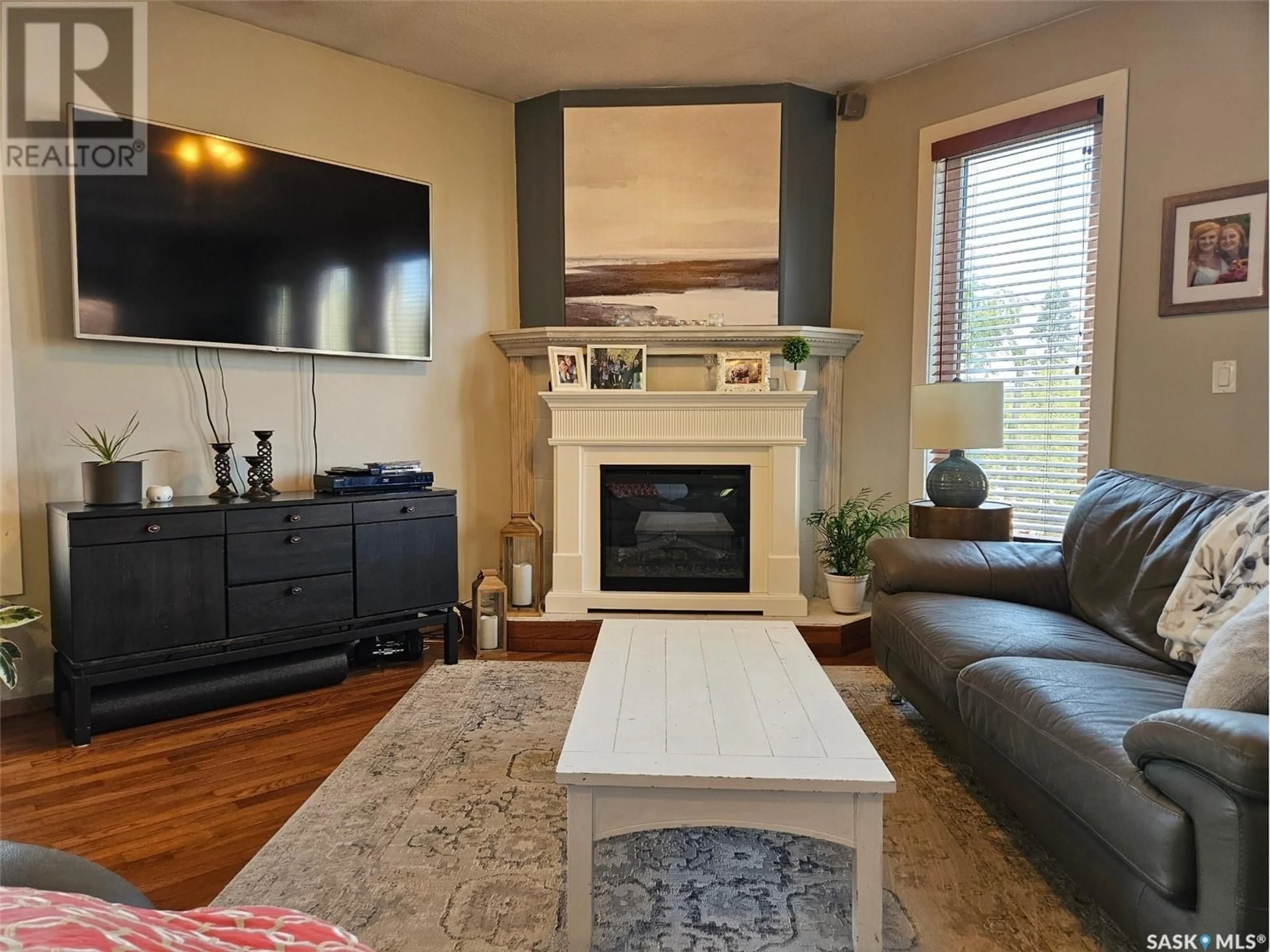 Living room with furniture, wood/laminate floor for 12 ALICE CRESCENT, Dufferin Rm No. 190 Saskatchewan S0H4C0
