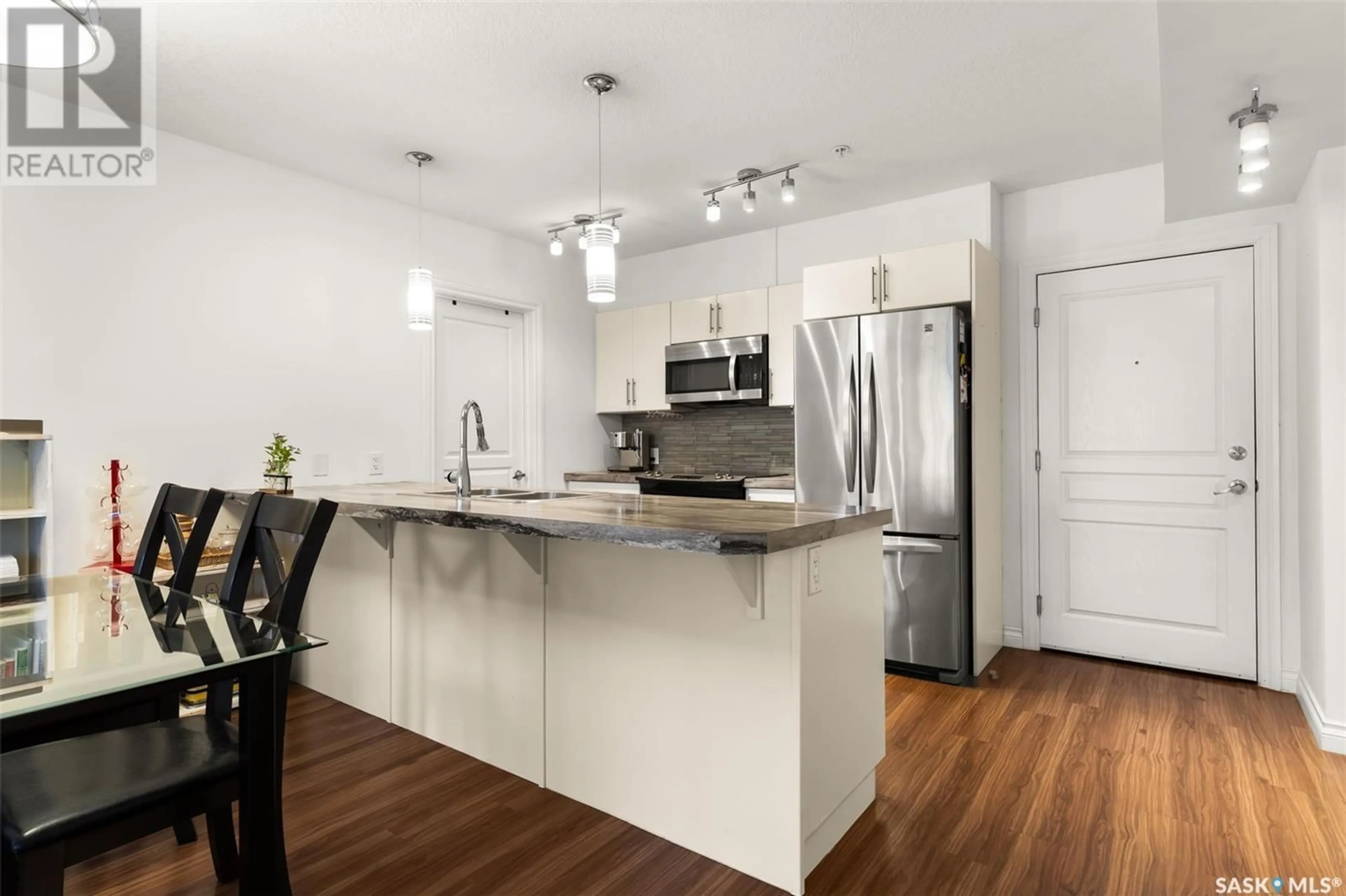 Open concept kitchen, wood/laminate floor for 123 5303 UNIVERSAL CRESCENT, Regina Saskatchewan S4W0L1