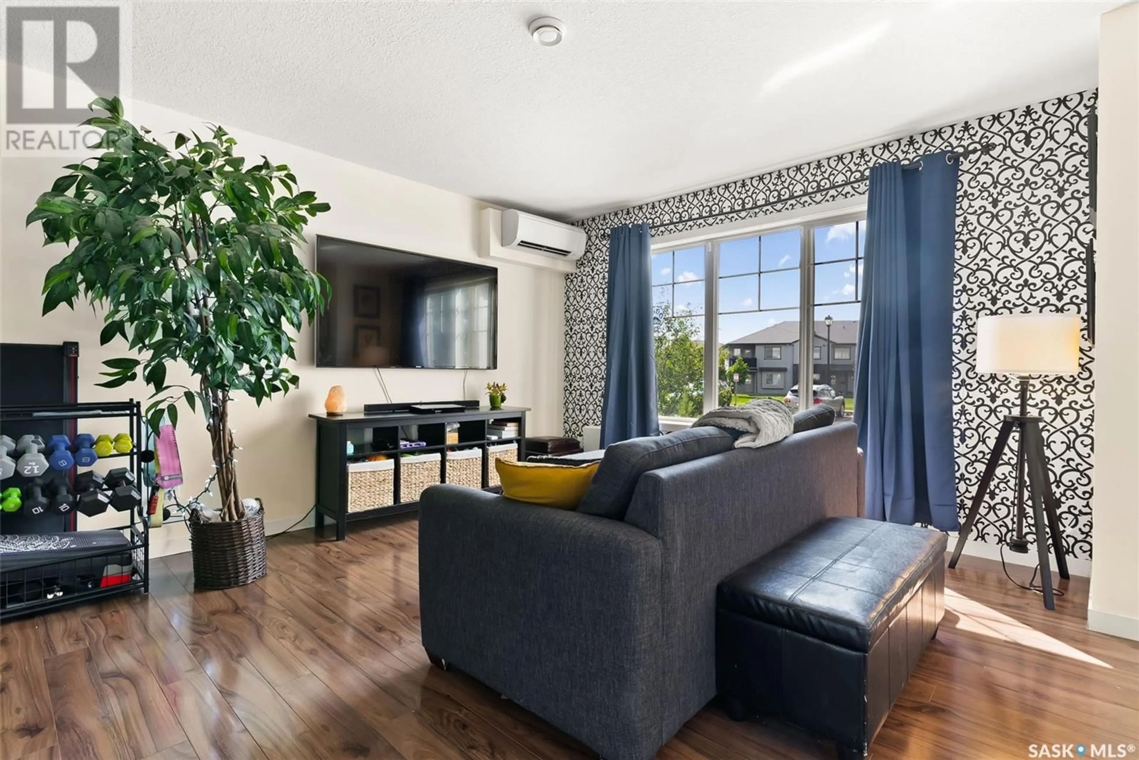 Living room with furniture, wood/laminate floor for #9 - 5011 JAMES HILL ROAD, Regina Saskatchewan S4W0B9