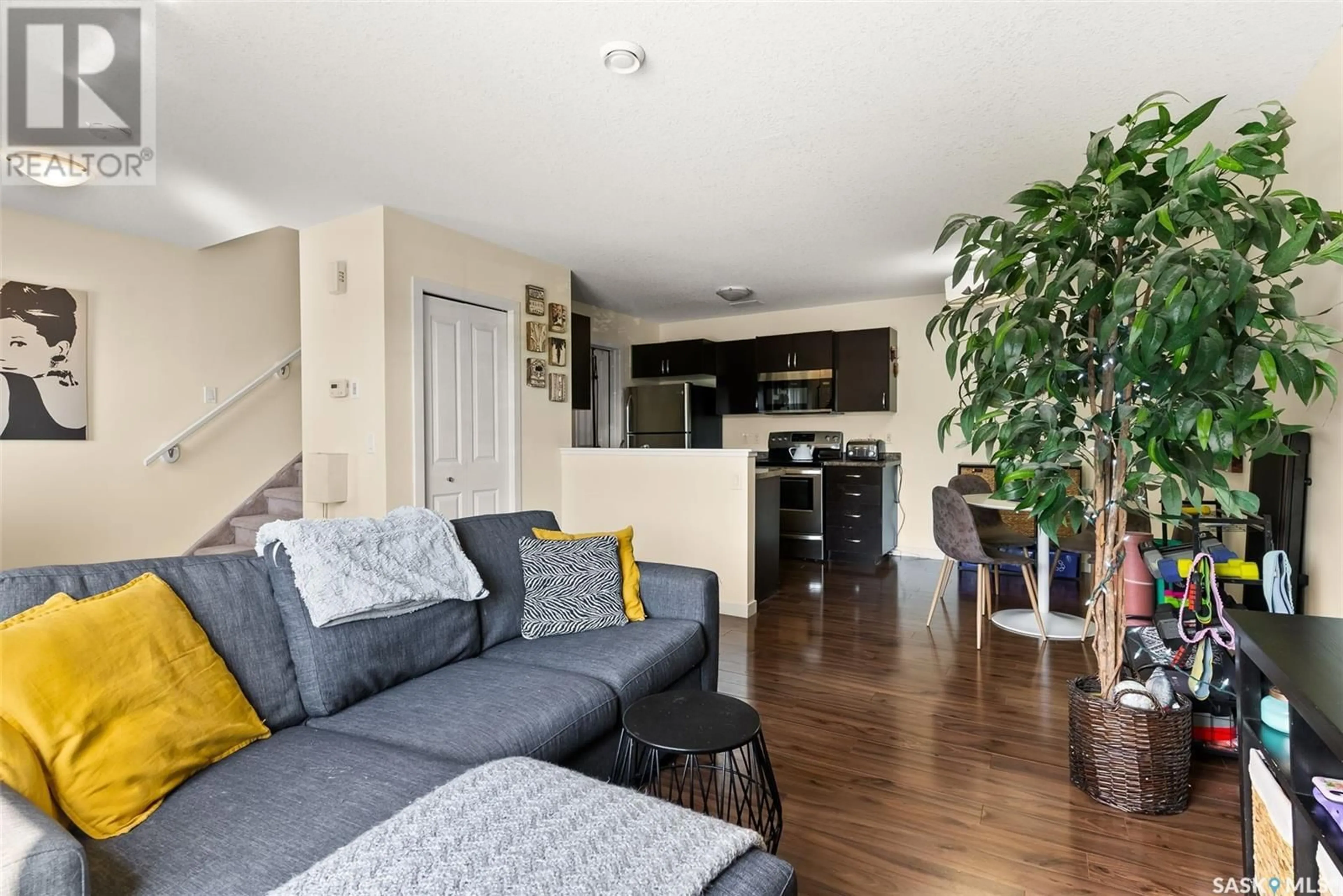 Living room with furniture, wood/laminate floor for #9 - 5011 JAMES HILL ROAD, Regina Saskatchewan S4W0B9