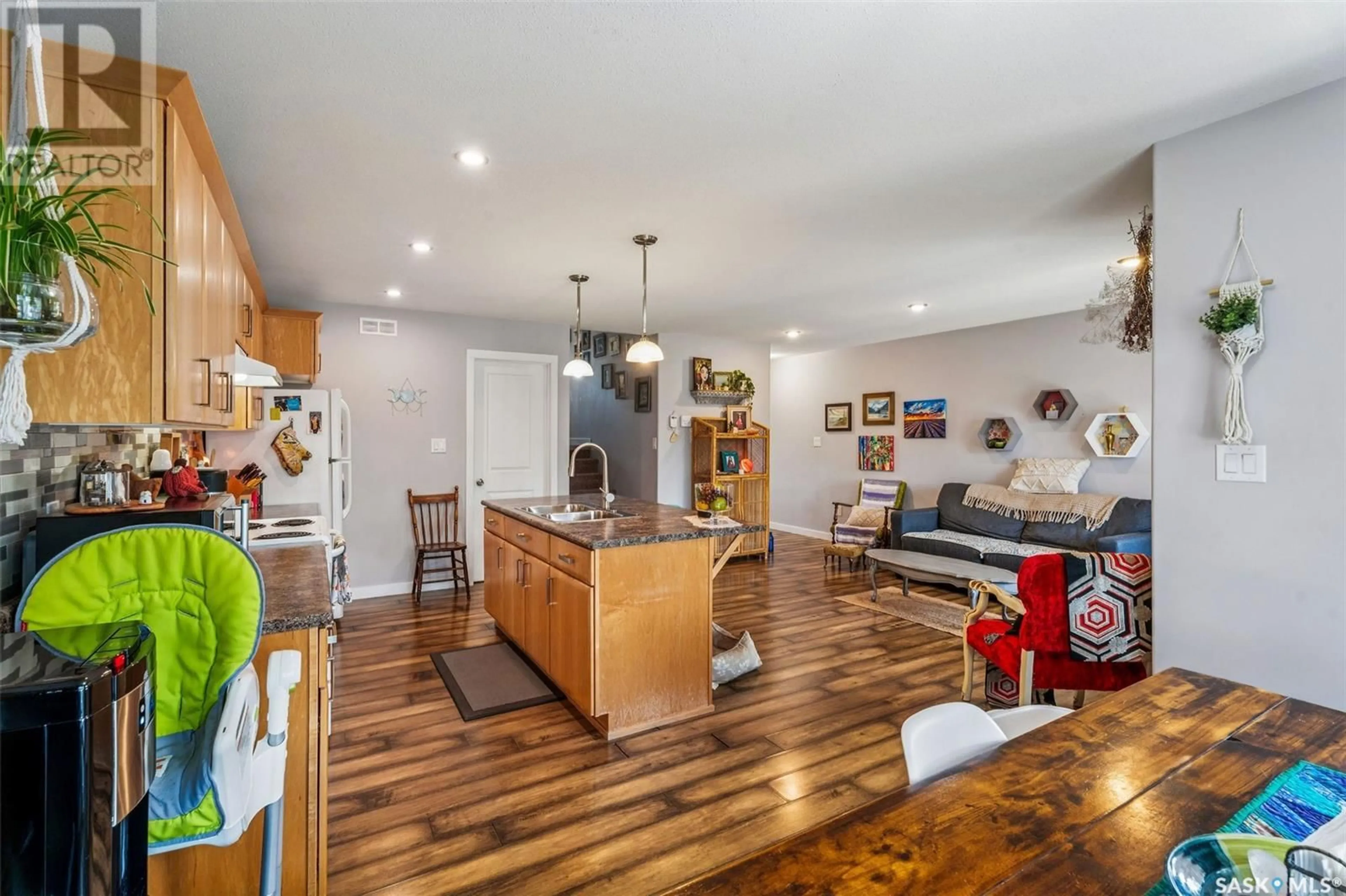 Open concept kitchen, wood/laminate floor for 897 5TH STREET, Prince Albert Saskatchewan S6V2L6