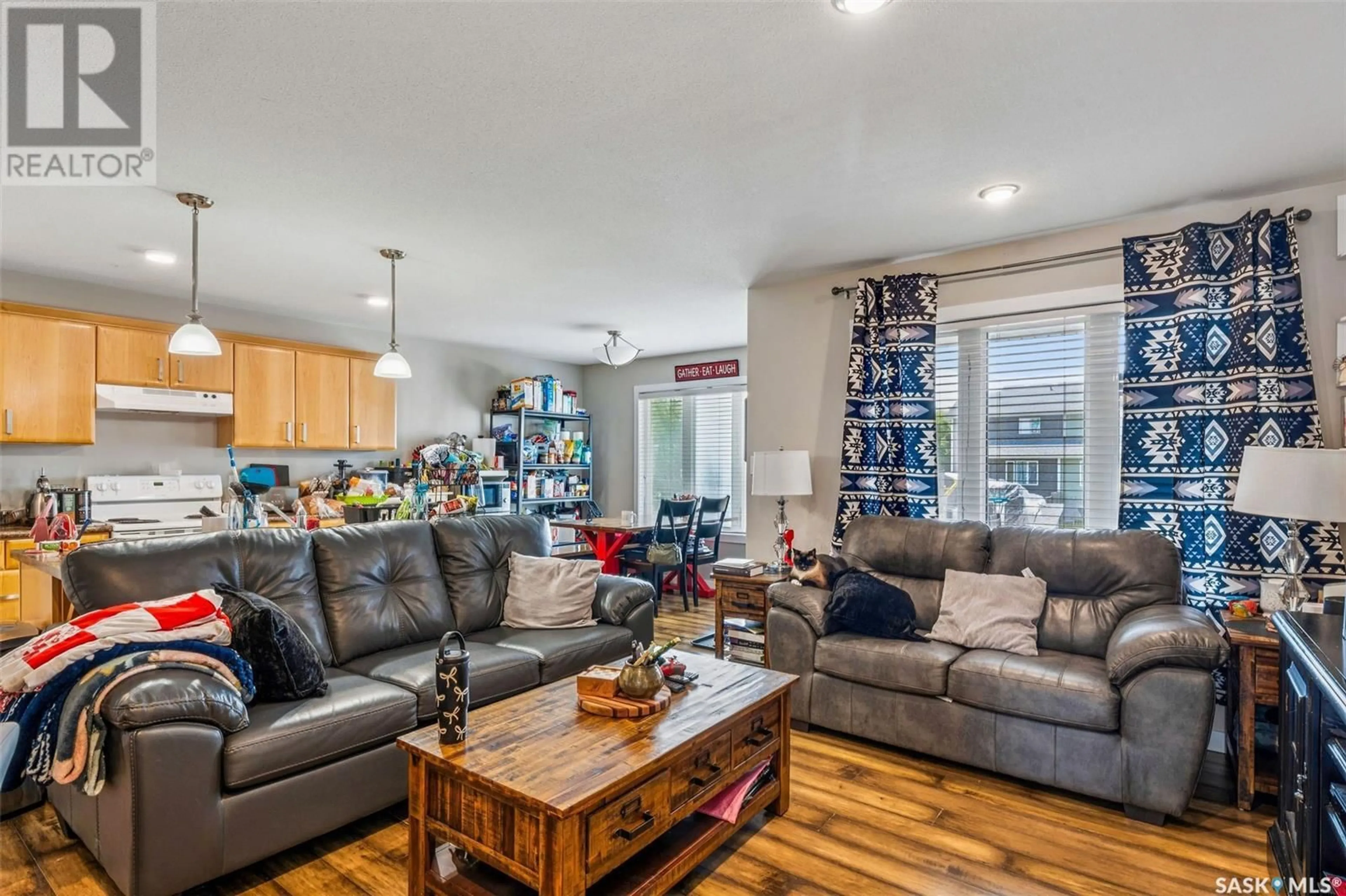 Living room with furniture, wood/laminate floor for 893 5TH STREET, Prince Albert Saskatchewan S6V2L6
