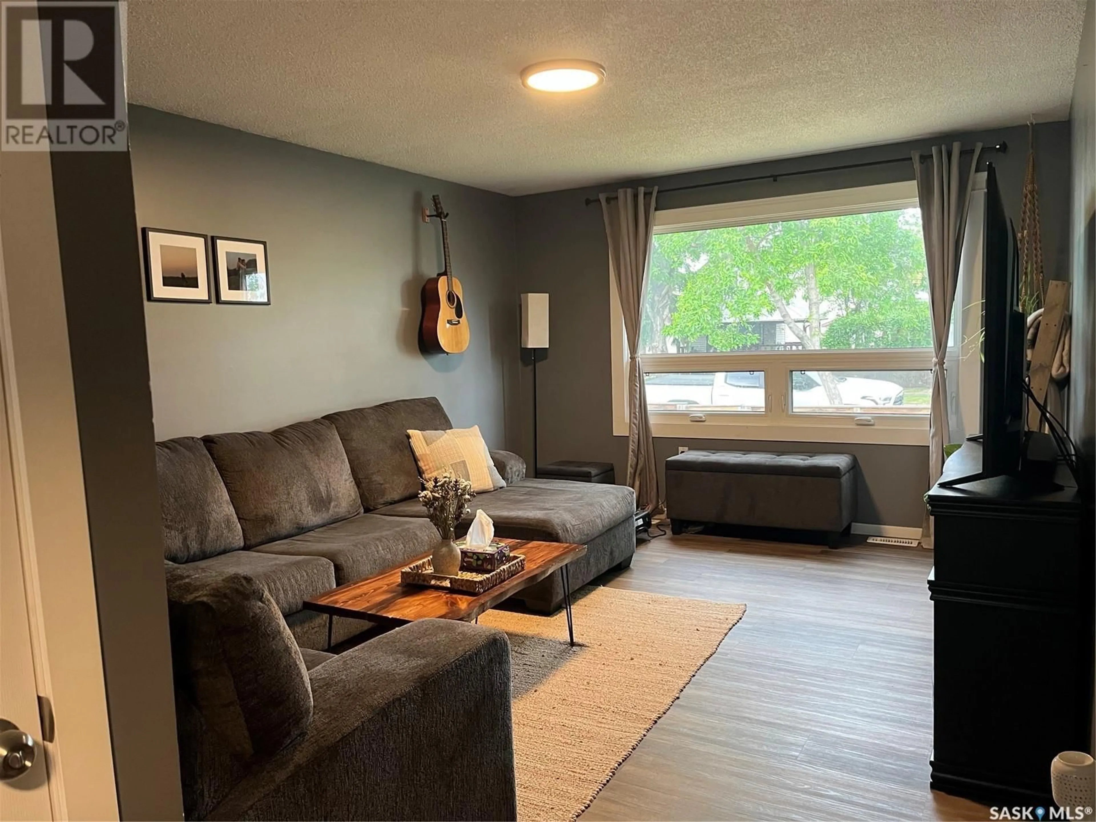Living room with furniture, wood/laminate floor for 445 11TH STREET, Prince Albert Saskatchewan S6V1A8