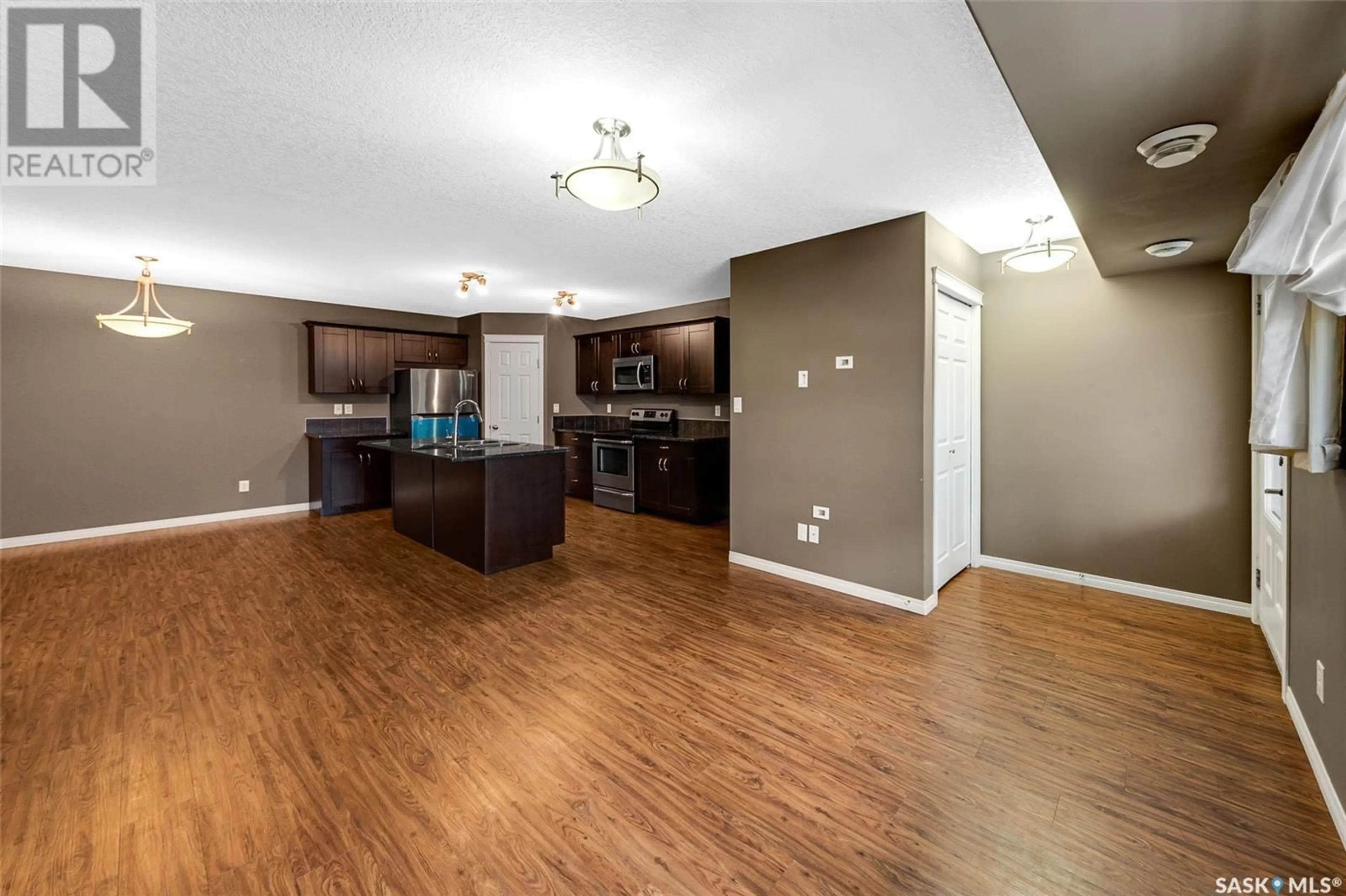 Open concept kitchen, wood/laminate floor for 125 - 135 WILLIS CRESCENT, Saskatoon Saskatchewan S7T0T1