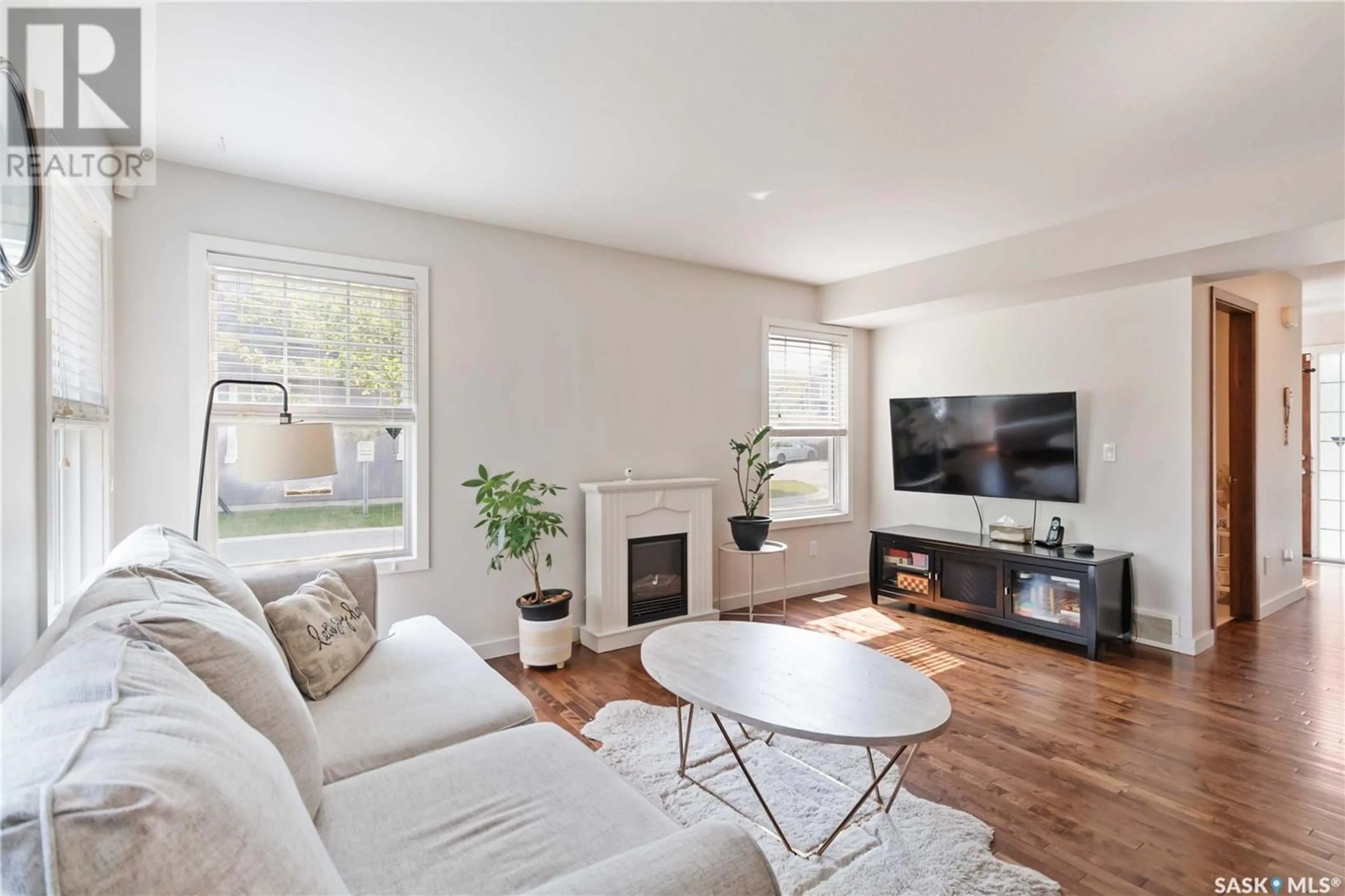 Living room with furniture, wood/laminate floor for 1303 - 606 PATON CRESCENT, Saskatoon Saskatchewan S7W0P9
