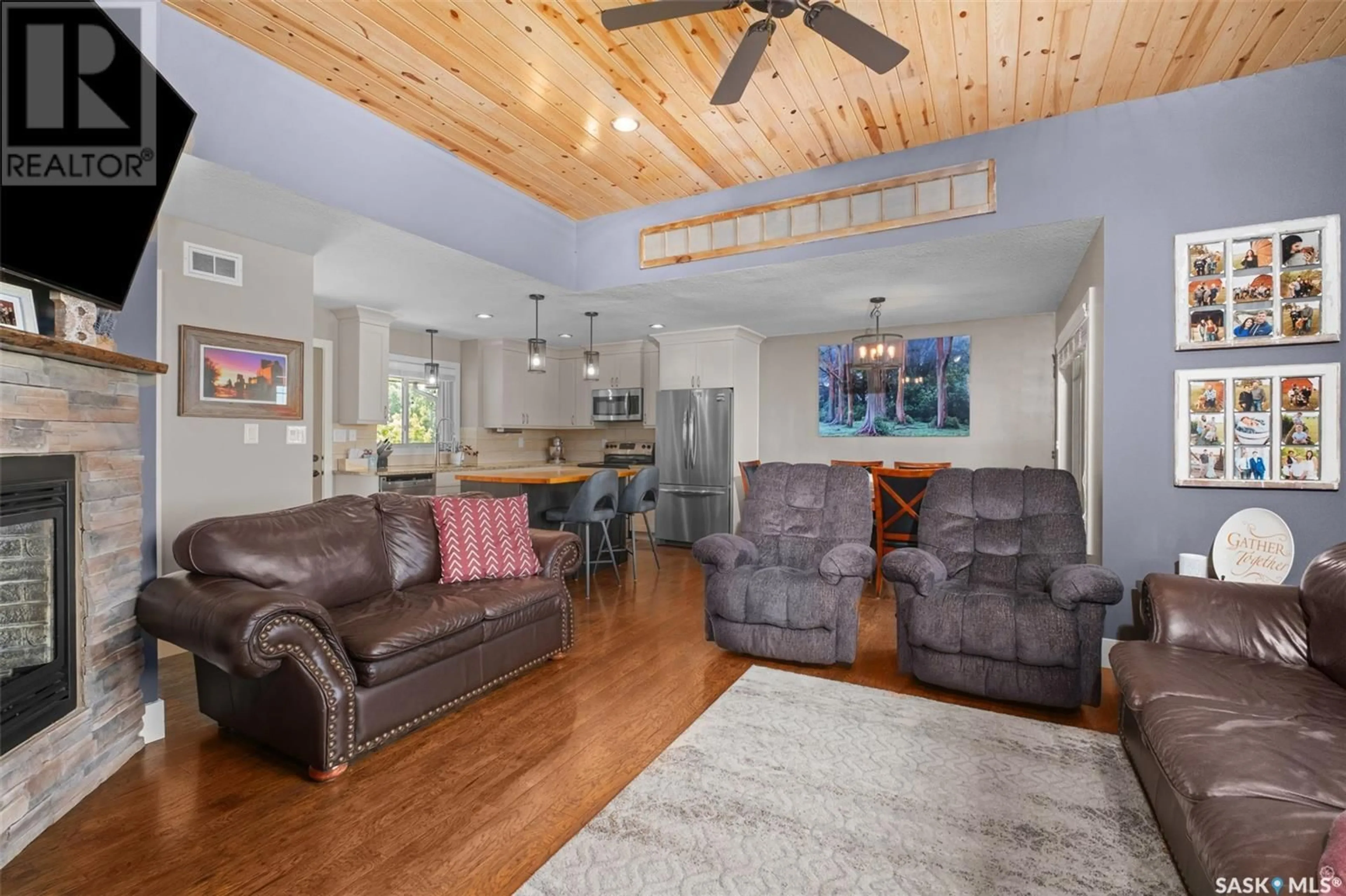 Living room with furniture, wood/laminate floor for 205 ASPEN COVE, Paddockwood Rm No. 520 Saskatchewan S0J0N0