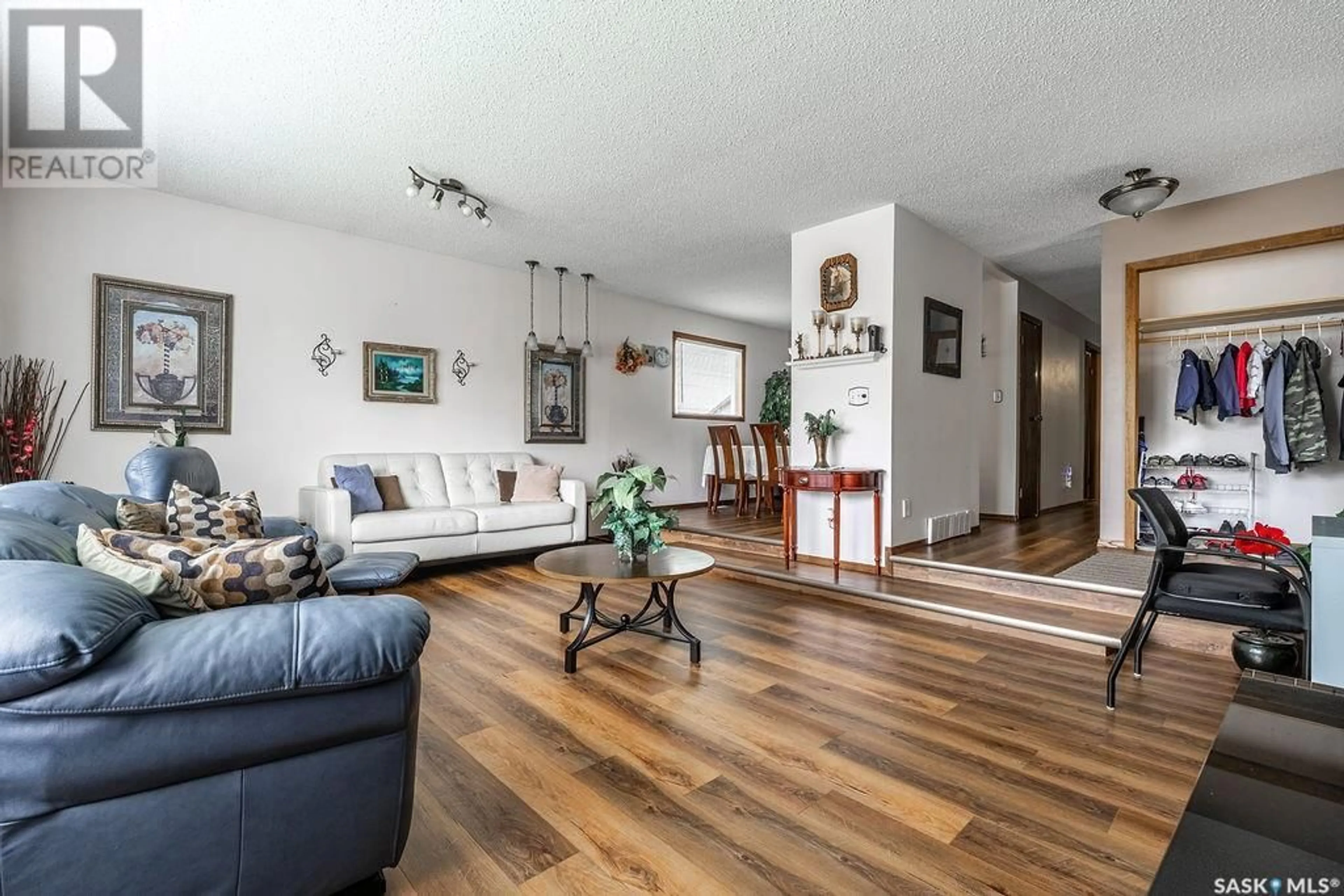 Living room with furniture, wood/laminate floor for 30 BAIN CRESCENT, Saskatoon Saskatchewan S7K6H4
