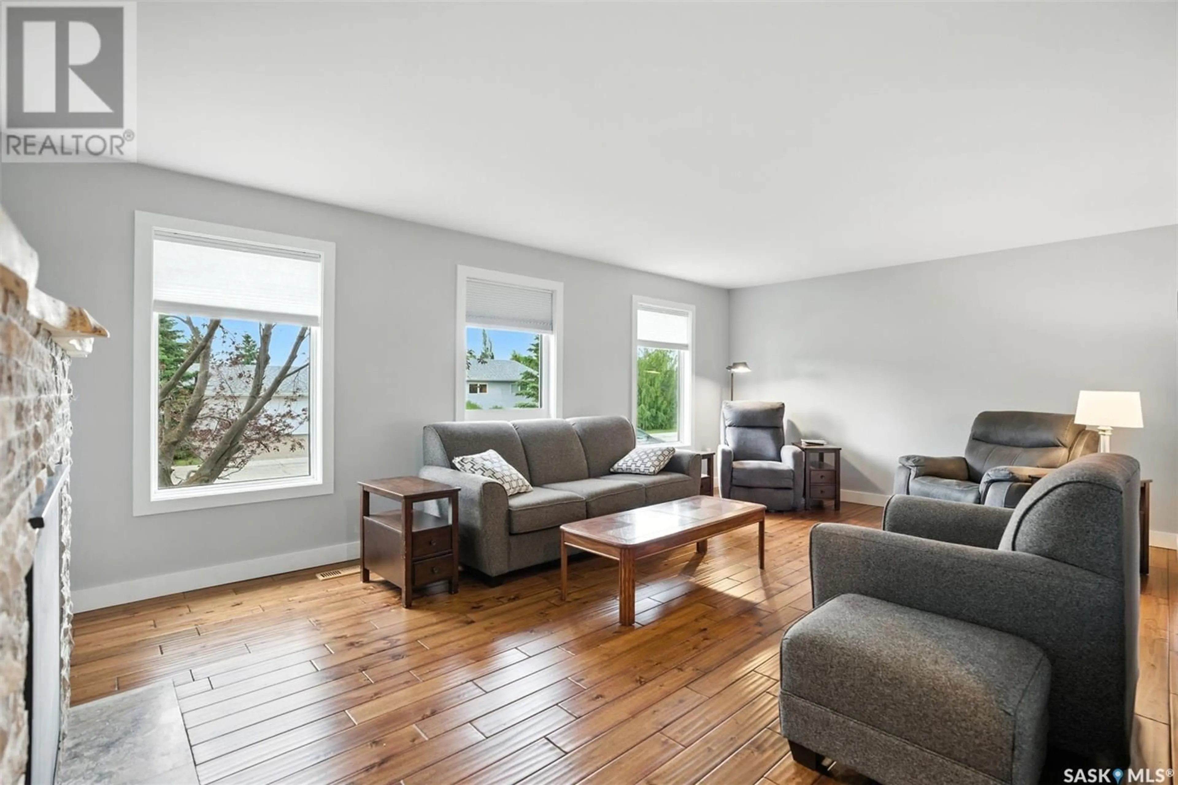 Living room with furniture, wood/laminate floor for 65 HOWARD CRESCENT, Lanigan Saskatchewan S0K2M0
