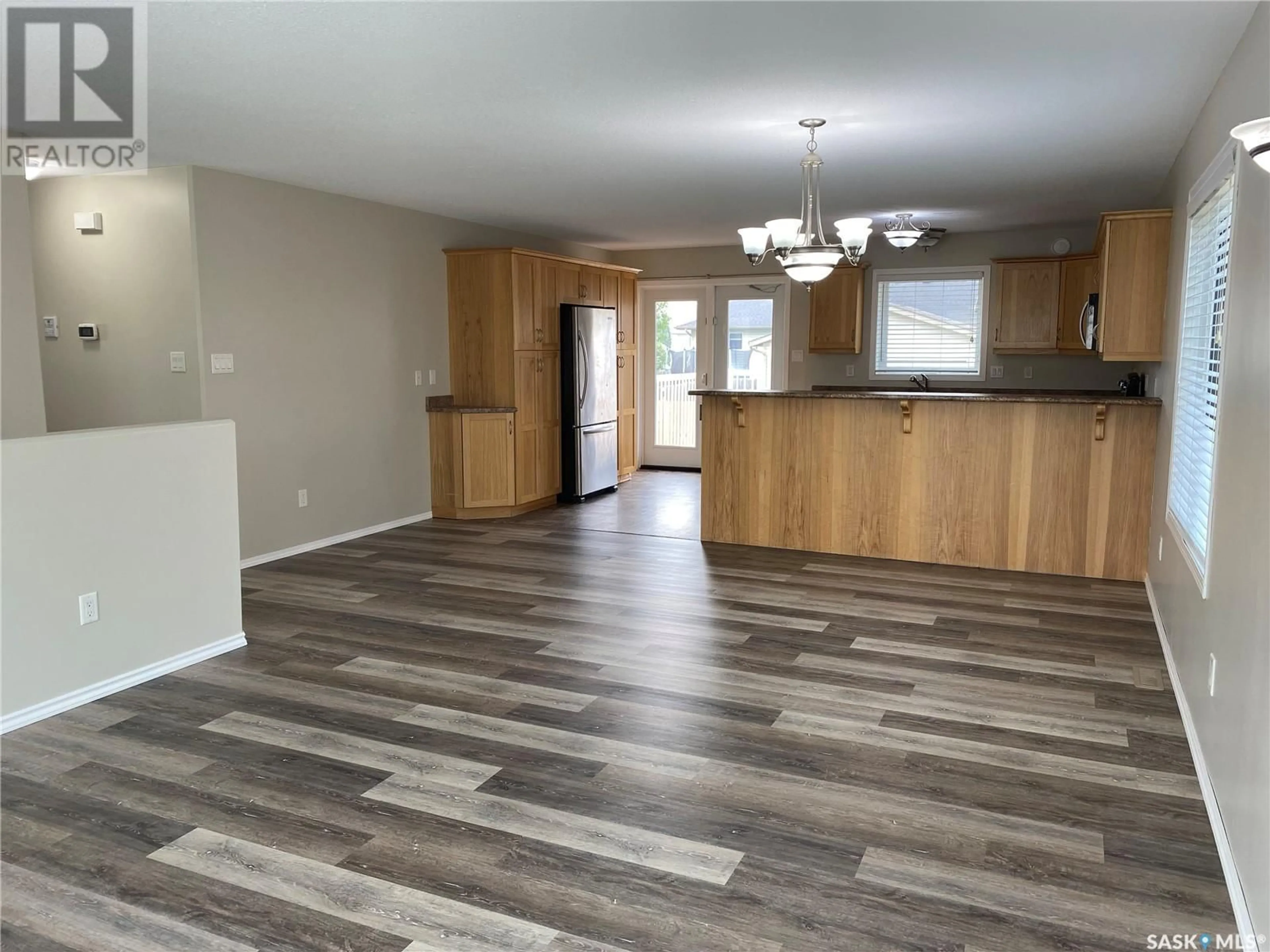 Open concept kitchen, wood/laminate floor for 606 7TH AVENUE, Meadow Lake Saskatchewan S9X1B1