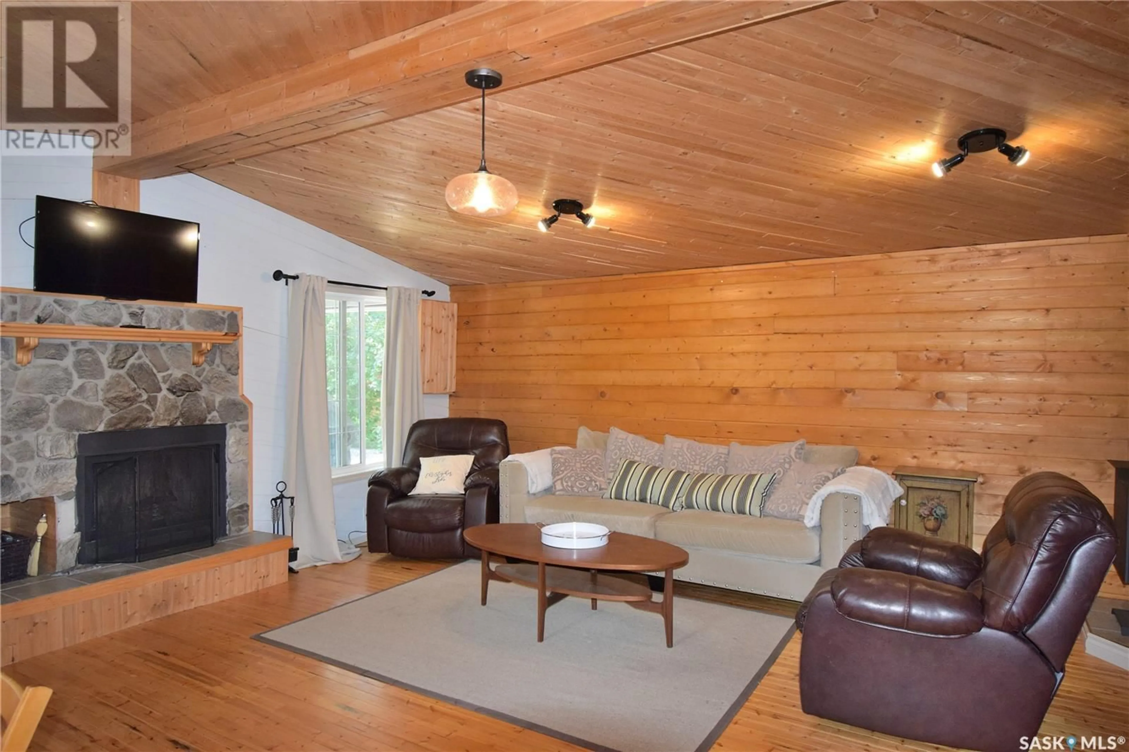 Living room with furniture, wood/laminate floor for 207 JACOBSON DRIVE, Lakeland Rm No. 521 Saskatchewan S0J0N0
