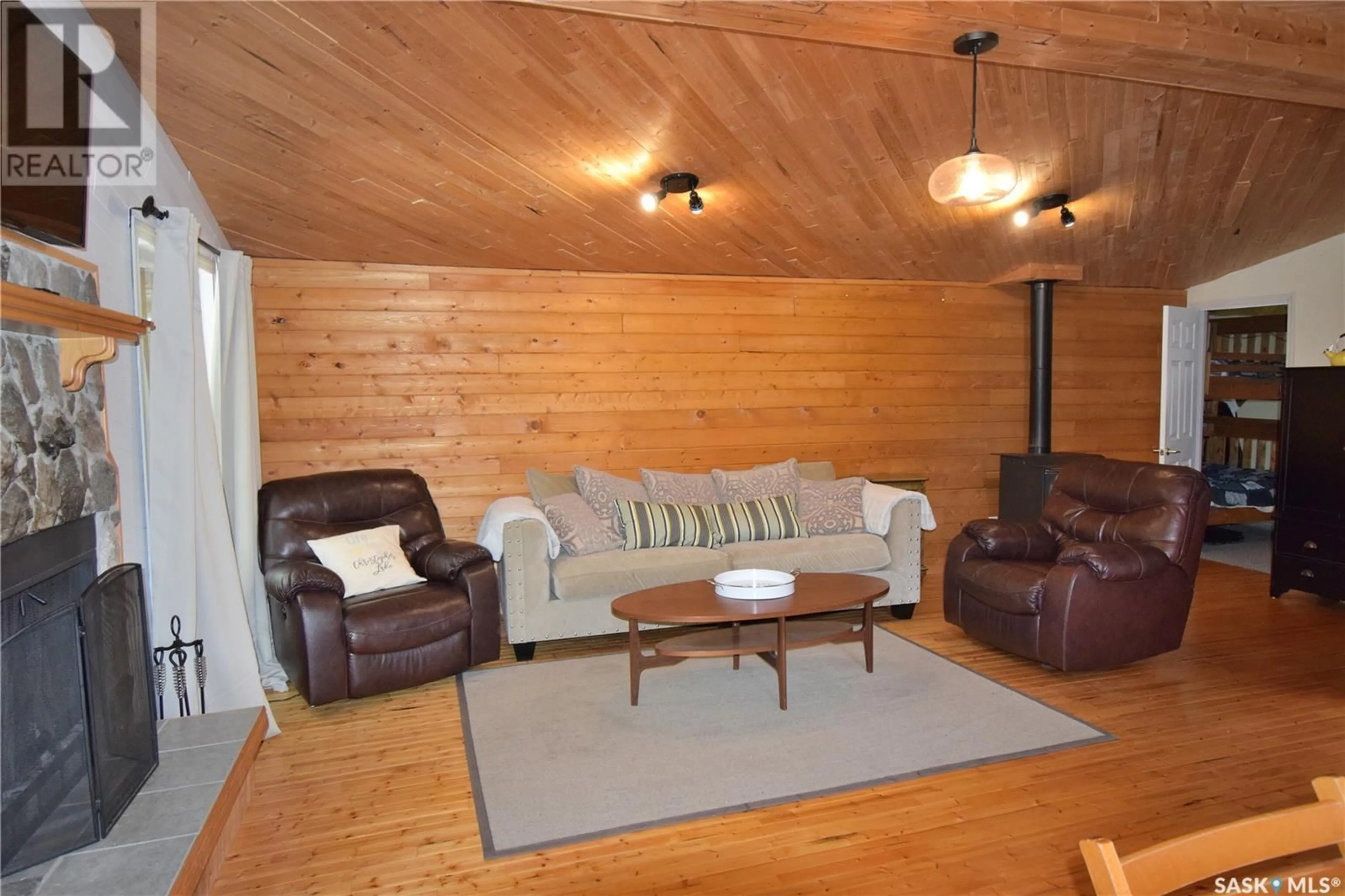 Living room with furniture, wood/laminate floor for 207 JACOBSON DRIVE, Lakeland Rm No. 521 Saskatchewan S0J0N0