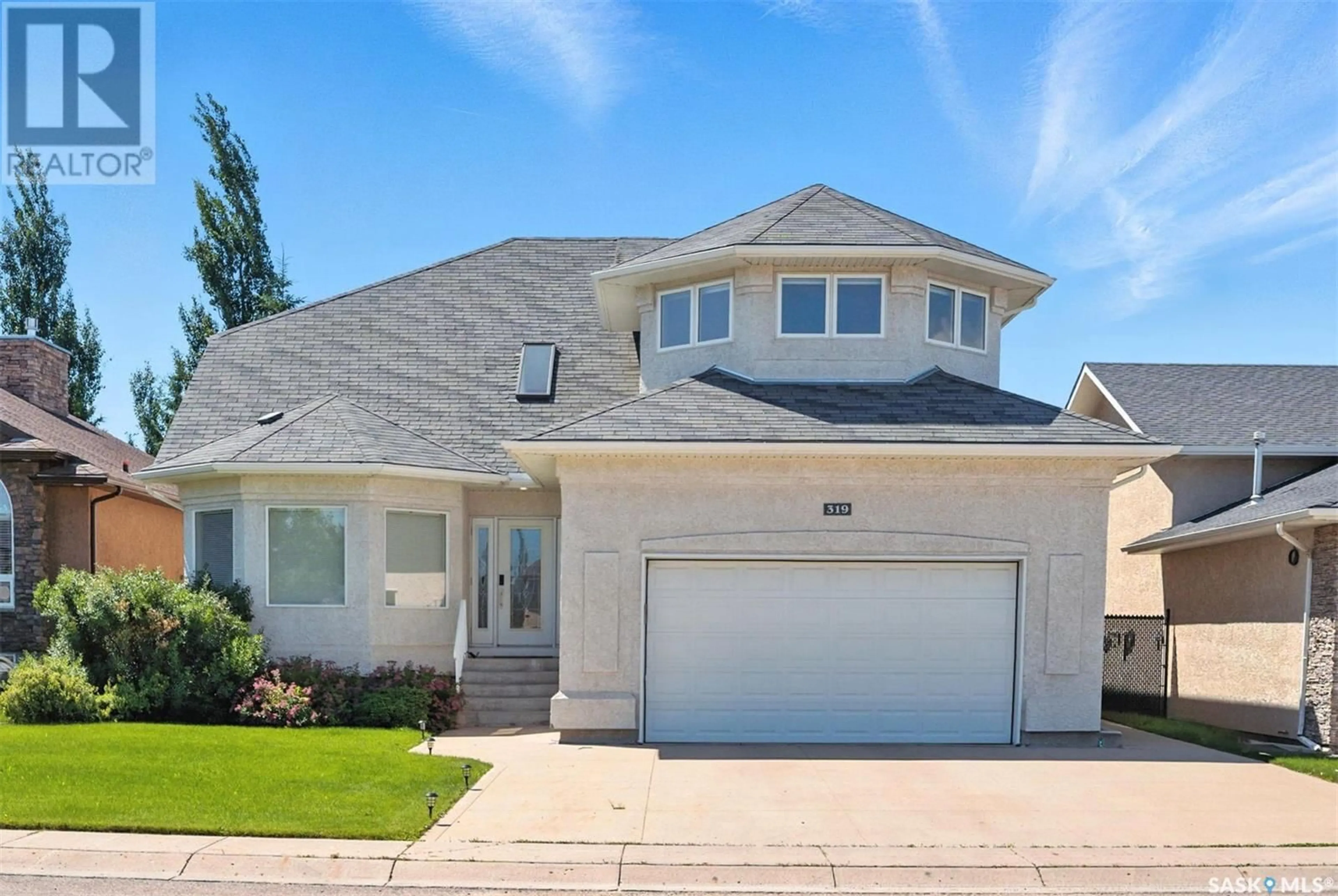 Home with vinyl exterior material, street for 319 THODE AVENUE, Saskatoon Saskatchewan S7W1A1