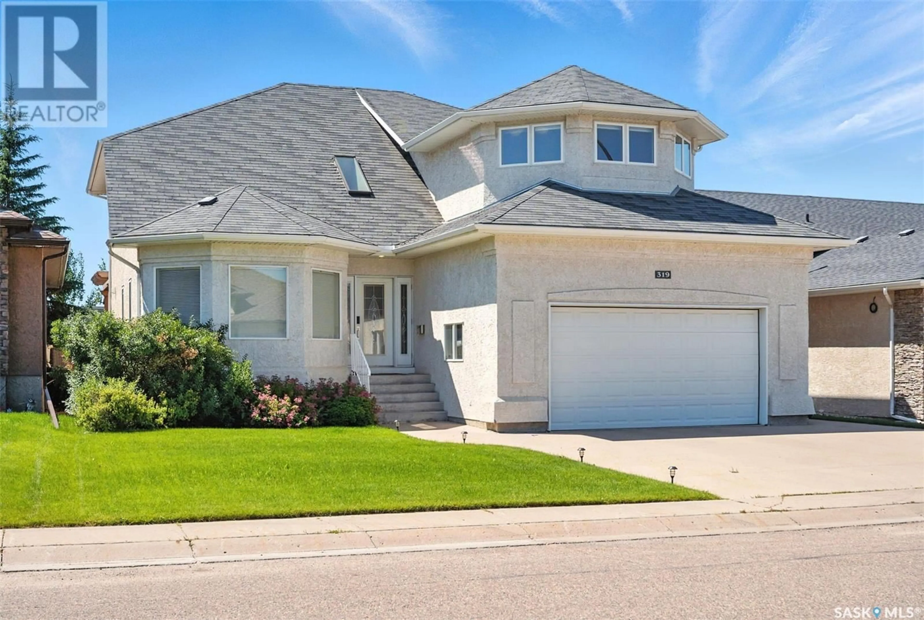 Home with vinyl exterior material, street for 319 THODE AVENUE, Saskatoon Saskatchewan S7W1A1