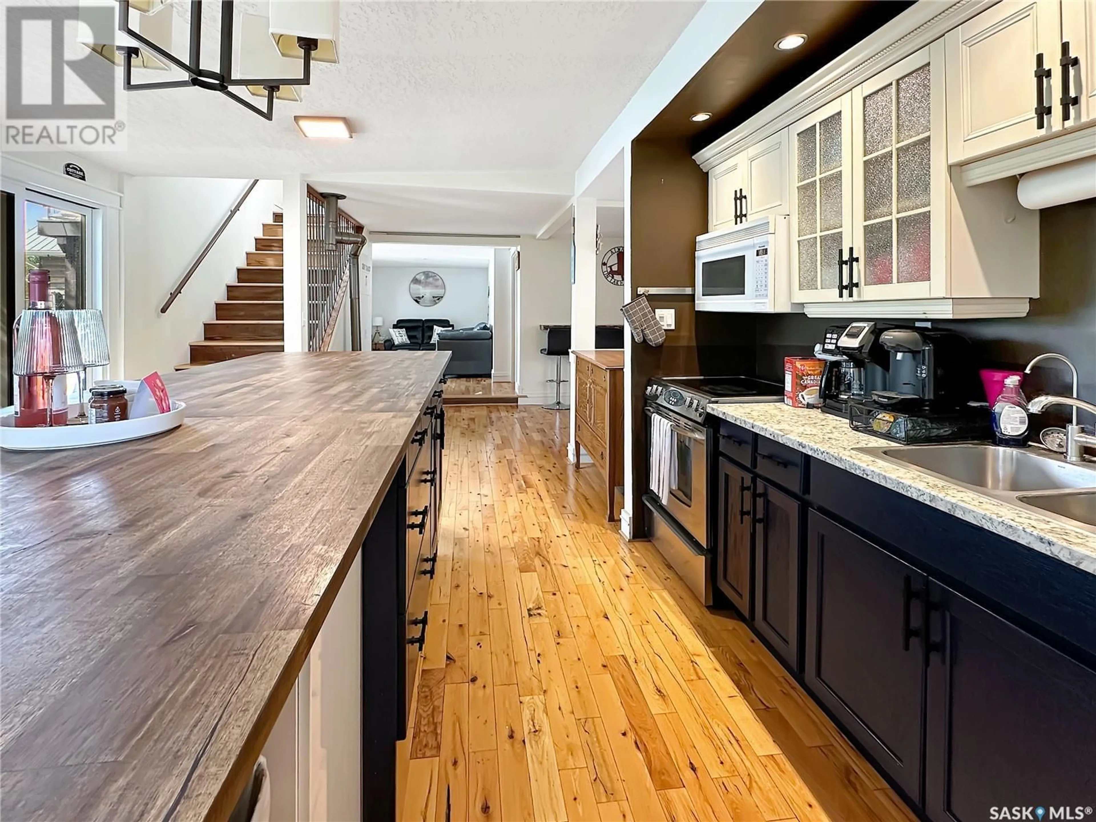 Open concept kitchen, wood/laminate floor for 402 PASQUA LAKE ROAD, North Qu'Appelle Rm No. 187 Saskatchewan S0G1S0