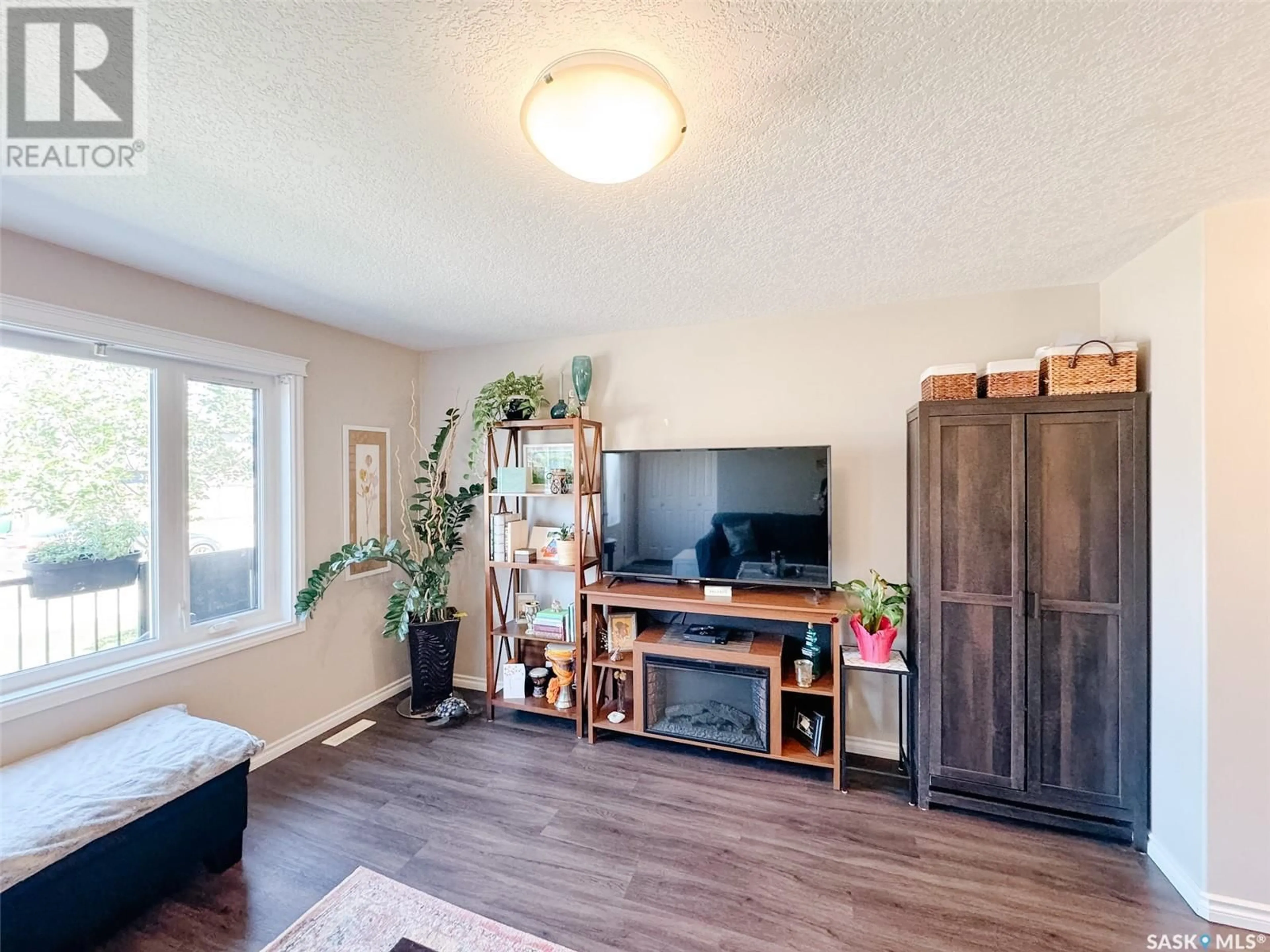 Living room with furniture, wood/laminate floor for 210 - 202 RAJPUT WAY, Saskatoon Saskatchewan S7W0V7
