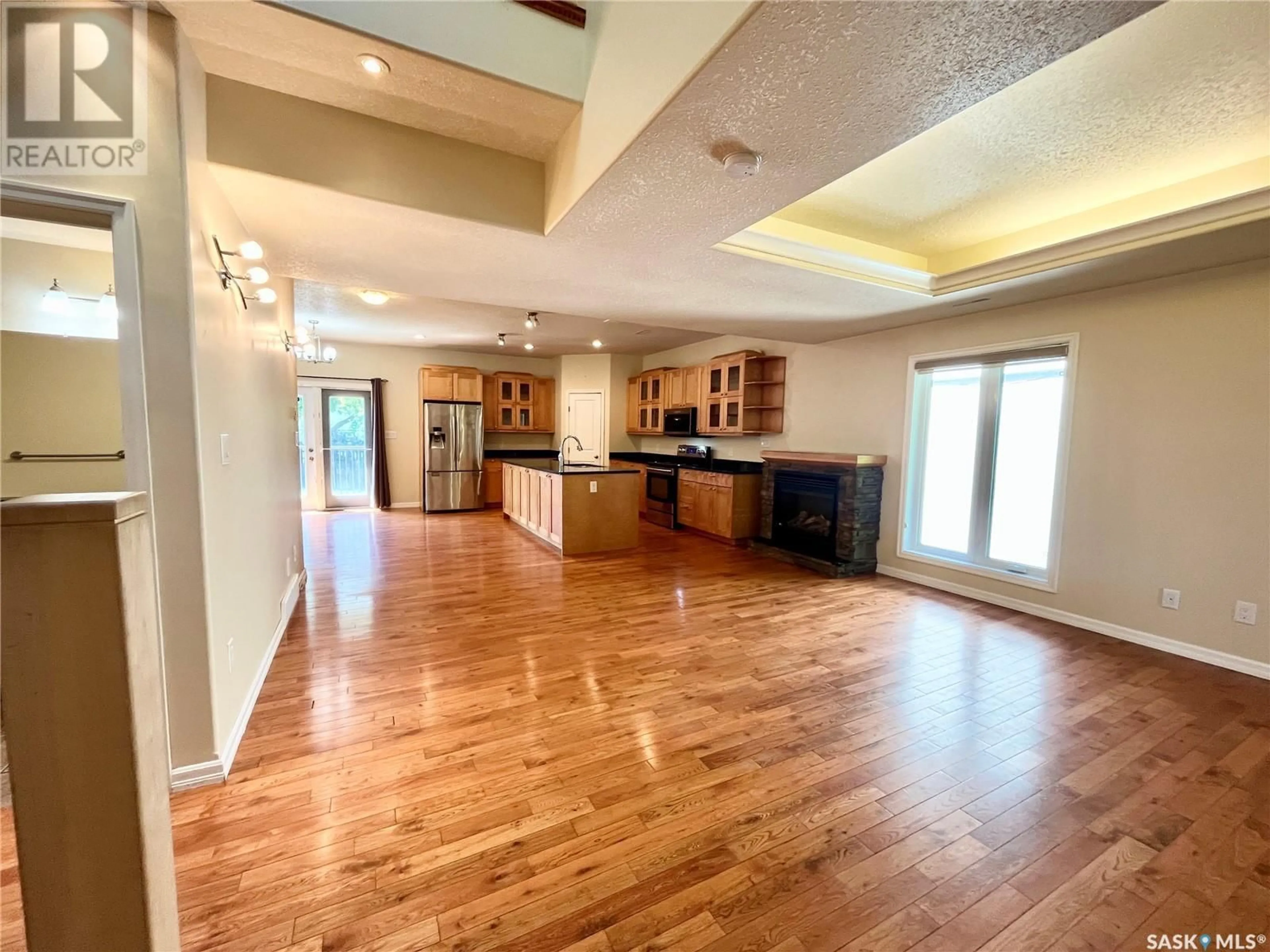 Open concept kitchen, wood/laminate floor for 4 211 20TH STREET, Prince Albert Saskatchewan S6V4G5