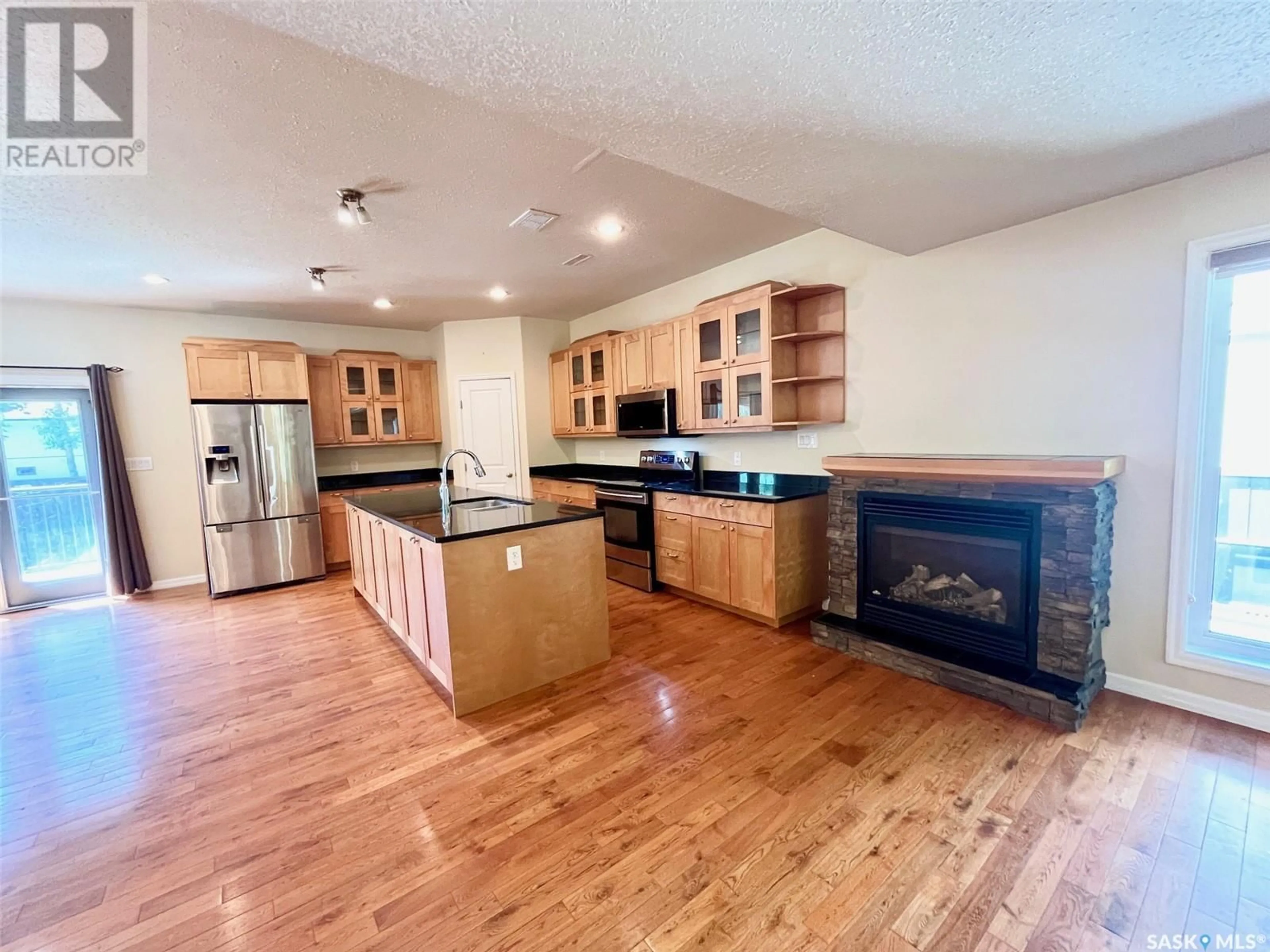 Open concept kitchen, wood/laminate floor for 4 211 20TH STREET, Prince Albert Saskatchewan S6V4G5