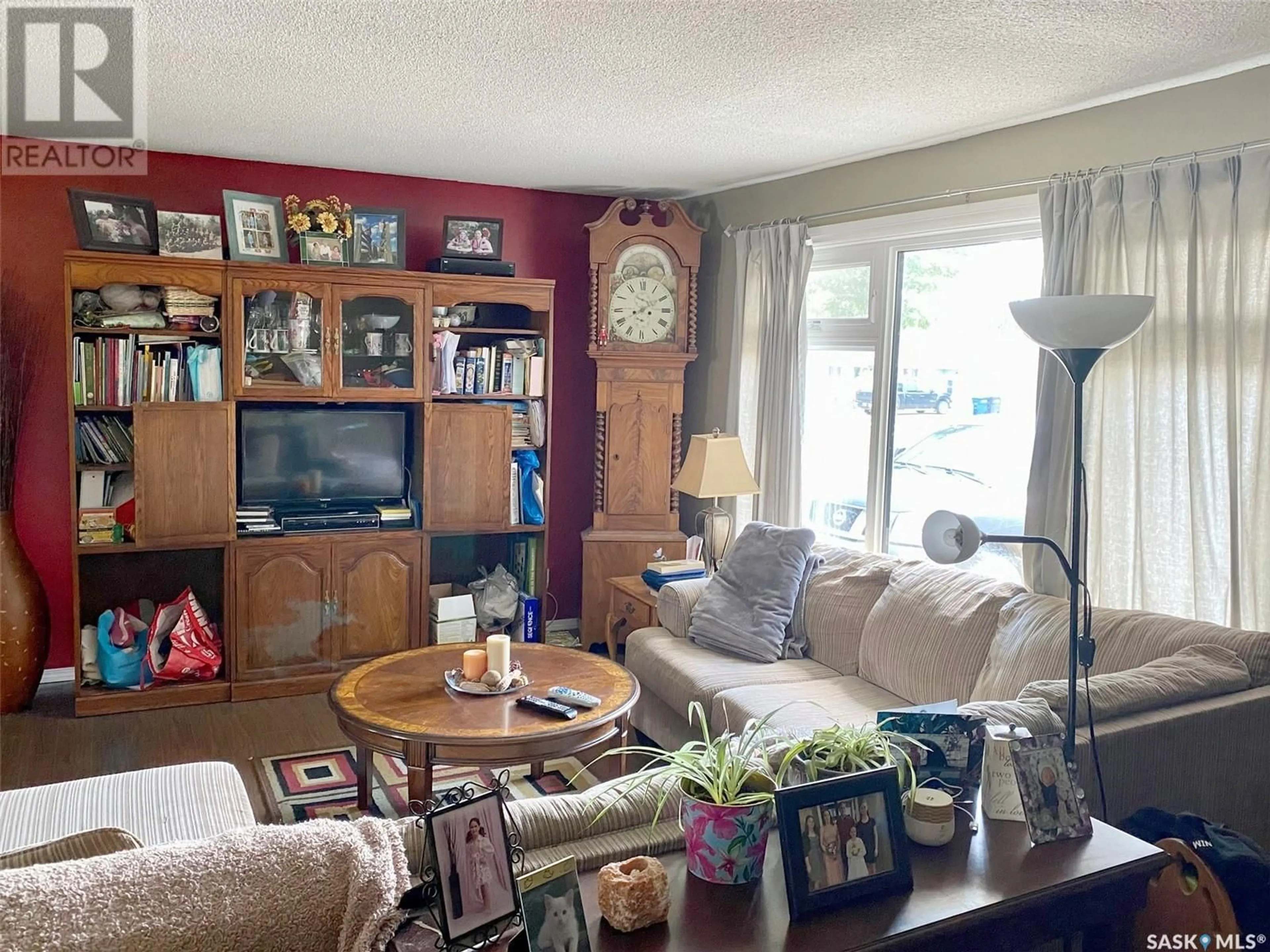 Living room with furniture, wood/laminate floor for 105 ASSINIBOIA AVENUE, Assiniboia Saskatchewan S0H0B0