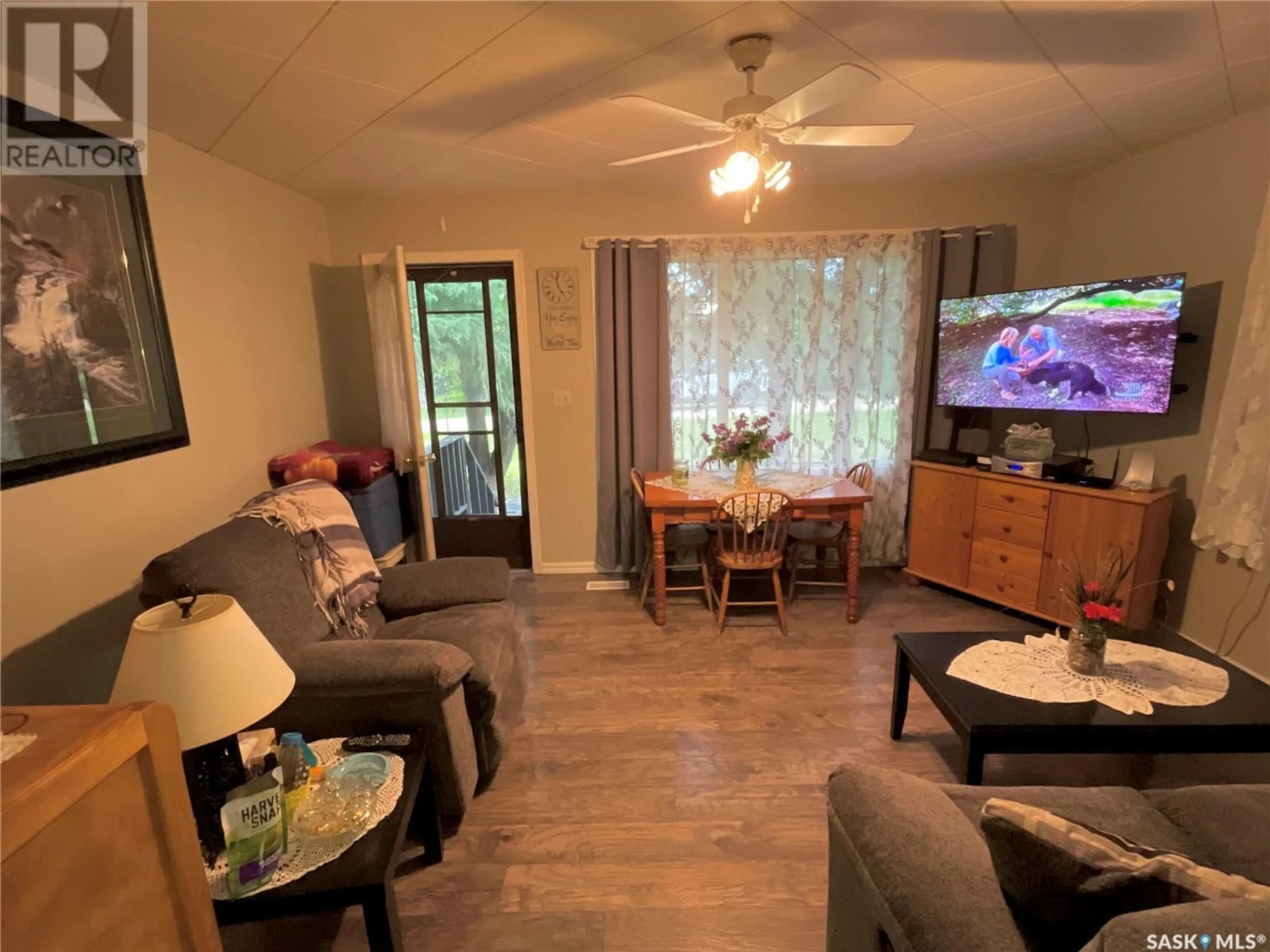 Living room with furniture, wood/laminate floor for 117 FIRST STREET, Wakaw Saskatchewan S0K4K0