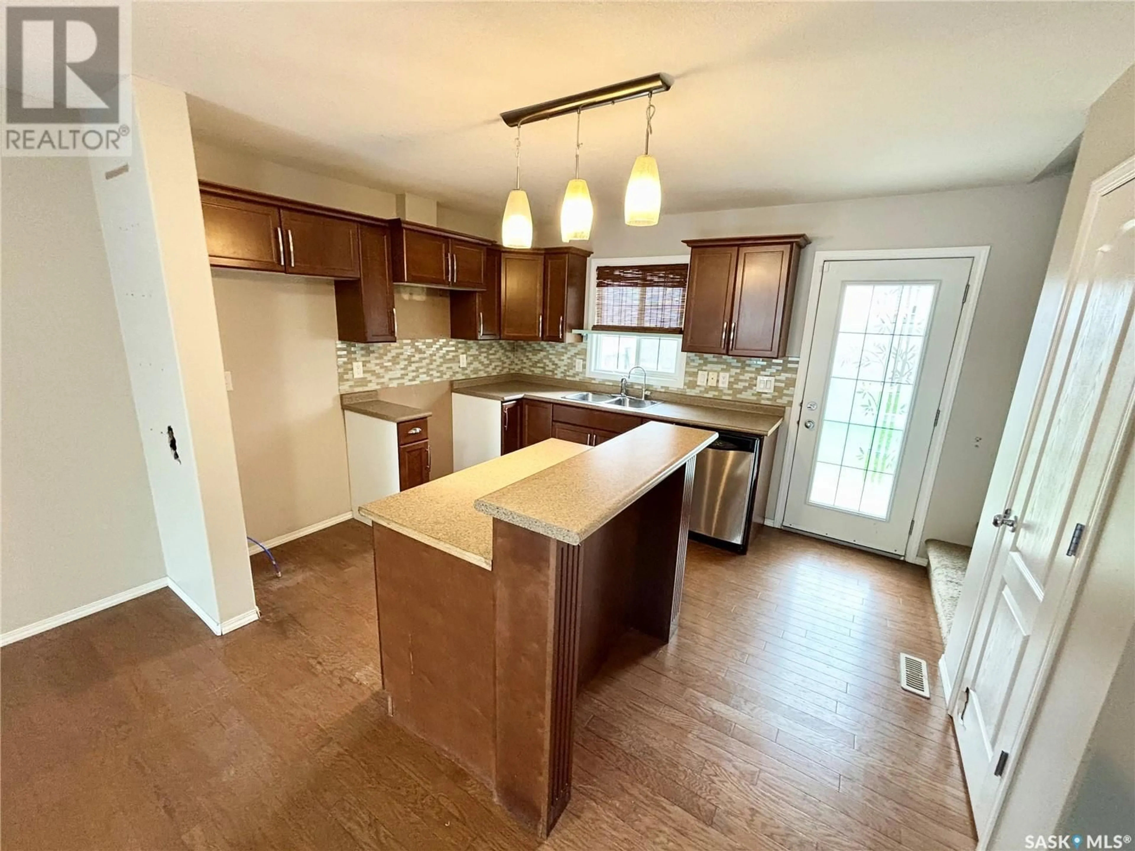 Open concept kitchen, wood/laminate floor for 158 4801 CHILD AVENUE, Regina Saskatchewan S4X0L7