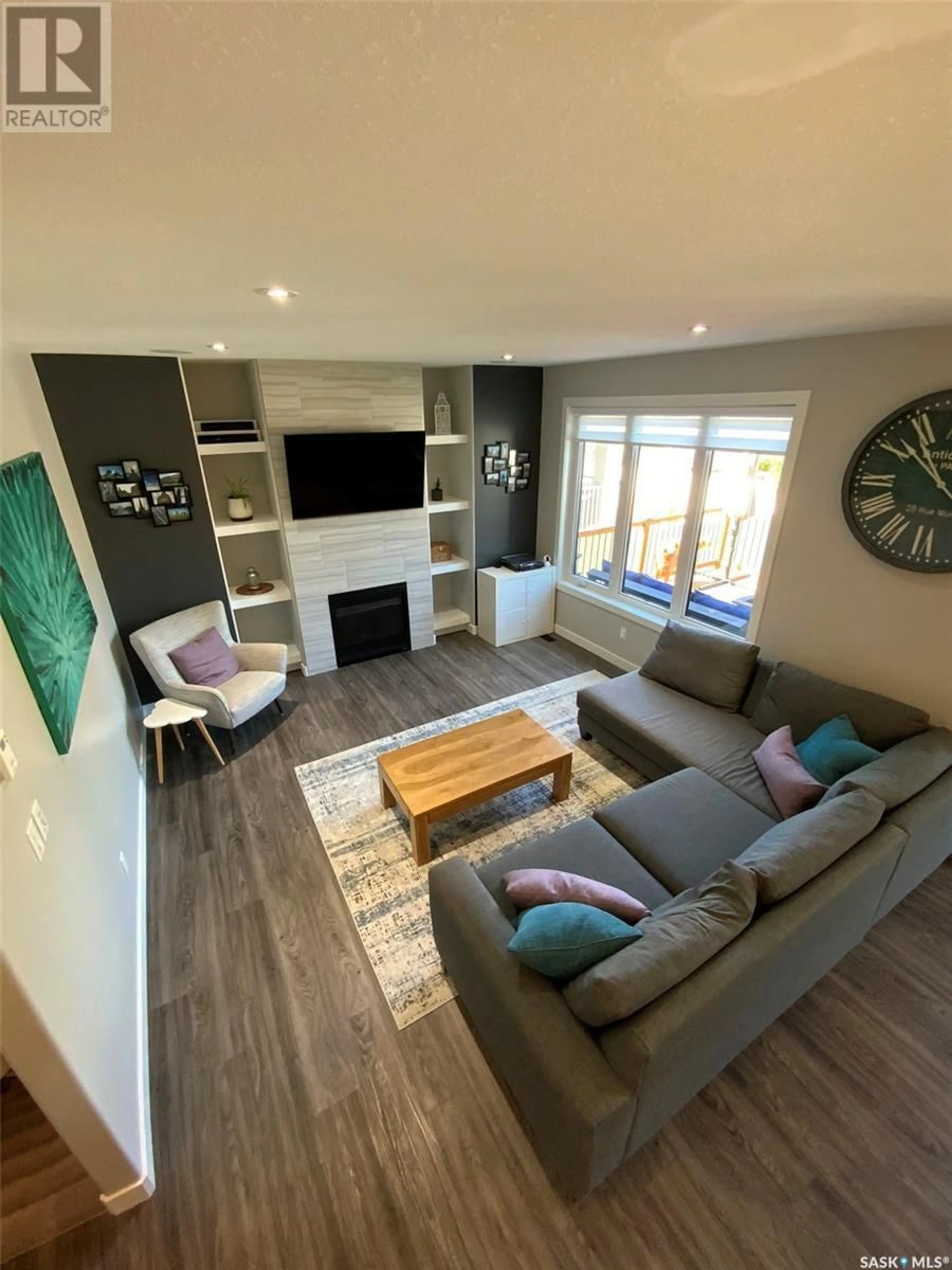 Living room with furniture, wood/laminate floor for 3310 GREEN BROOK ROAD, Regina Saskatchewan S4V3K2