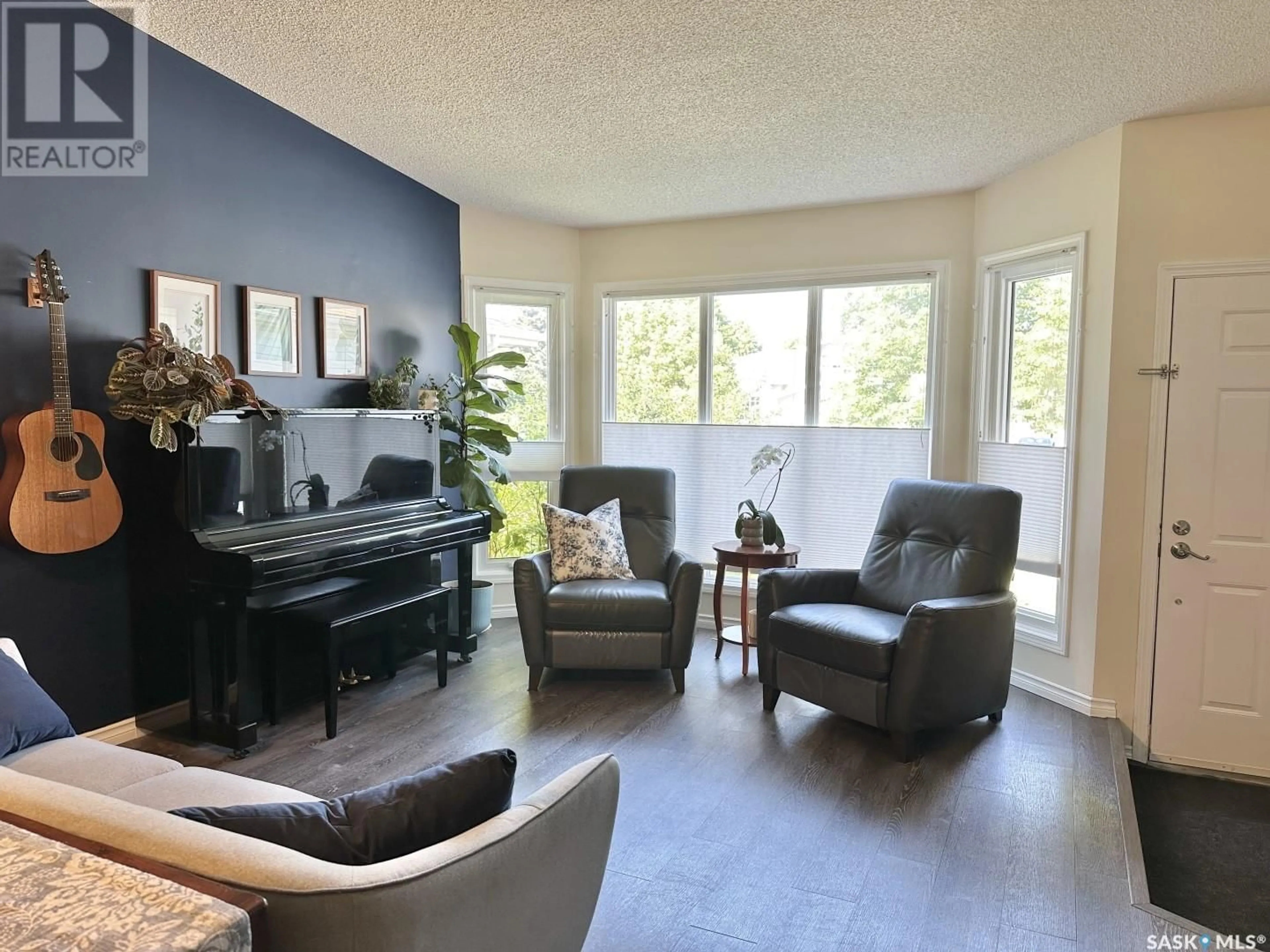 Living room with furniture, wood/laminate floor for 310 COBEN CRESCENT, Saskatoon Saskatchewan S7S1B3