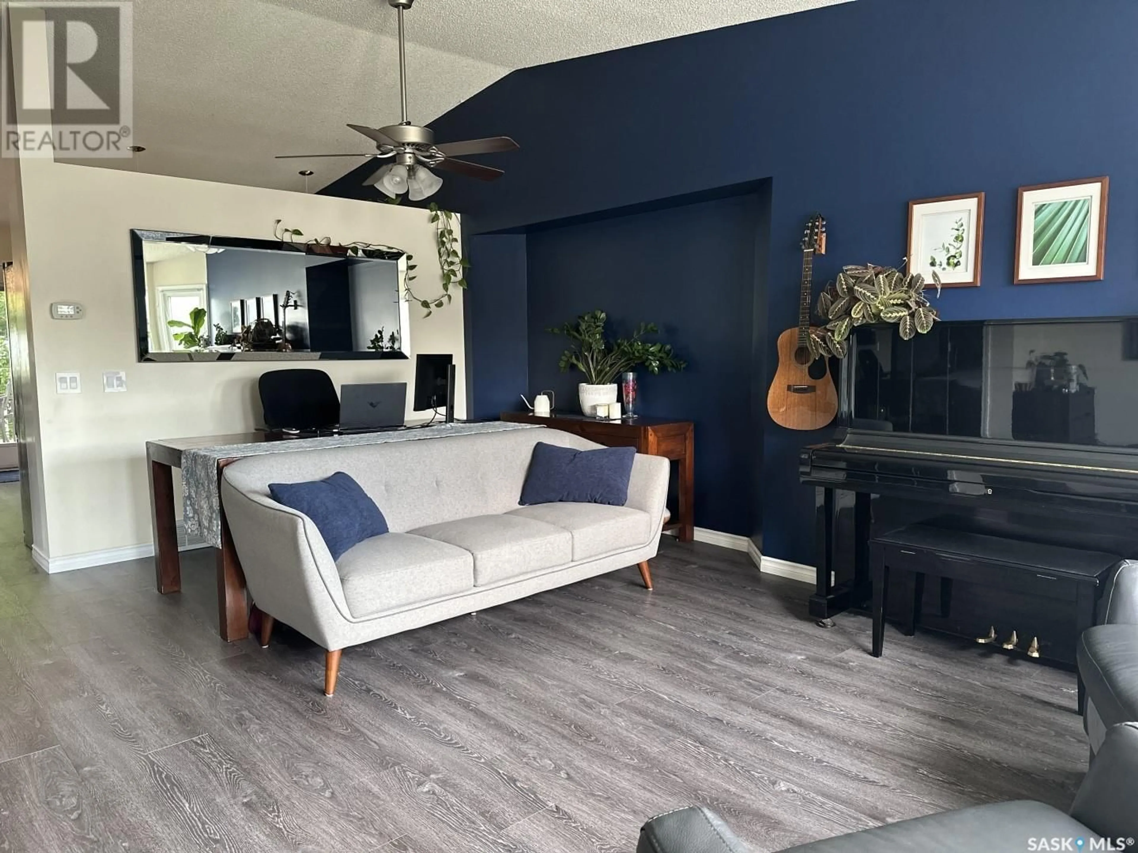 Living room with furniture, wood/laminate floor for 310 COBEN CRESCENT, Saskatoon Saskatchewan S7S1B3