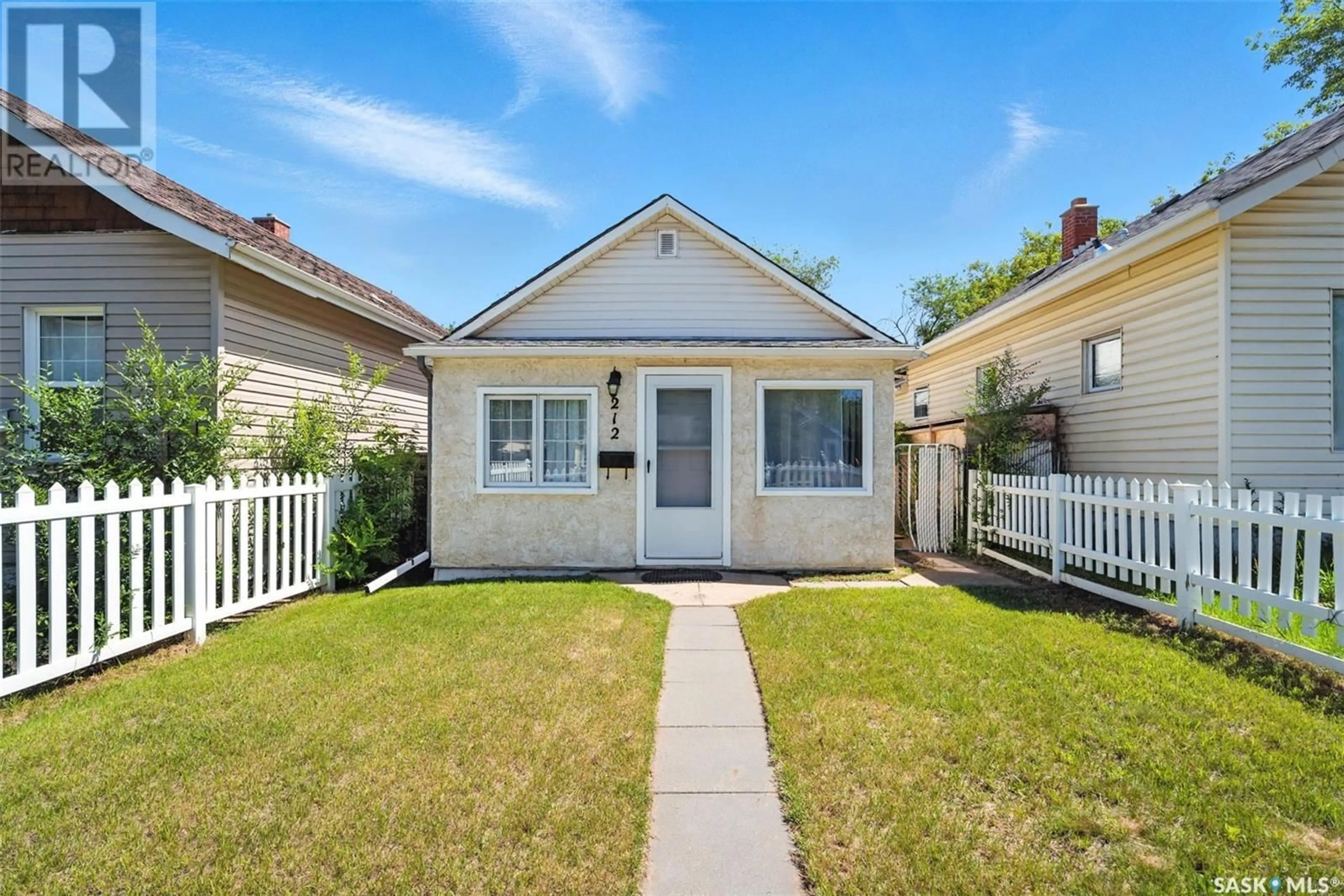 Home with vinyl exterior material, street for 212 K AVENUE, Saskatoon Saskatchewan S7M2C8