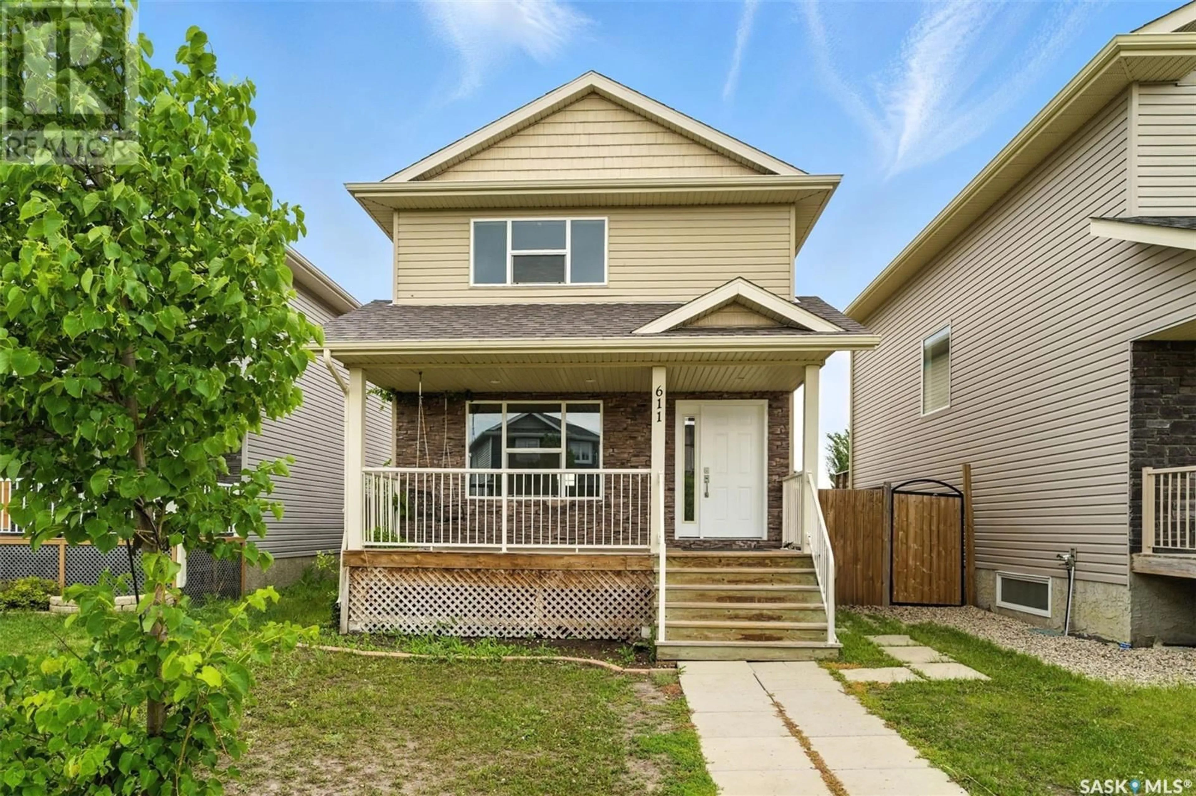 Home with vinyl exterior material, street for 611 PADGET LANE, Saskatoon Saskatchewan S7M0H3