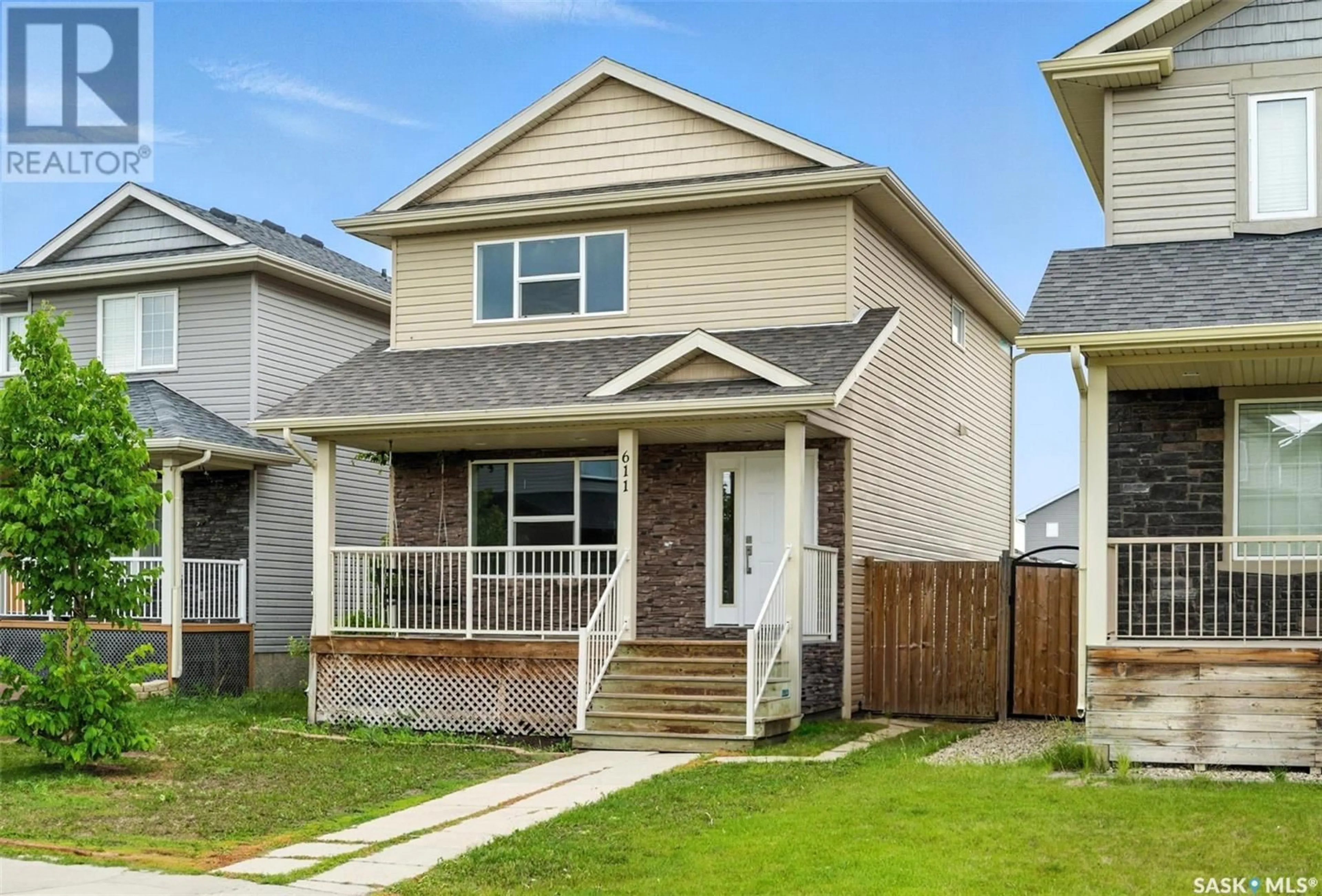 Home with vinyl exterior material, street for 611 PADGET LANE, Saskatoon Saskatchewan S7M0H3