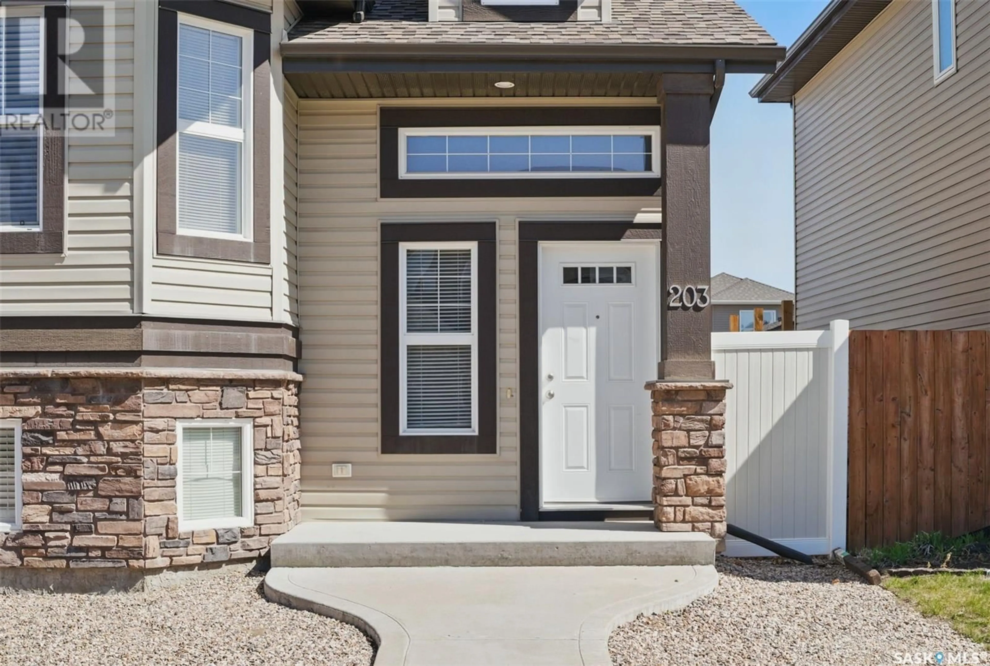 Home with vinyl exterior material, street for 203 LANGLOIS WAY, Saskatoon Saskatchewan S7T0K8