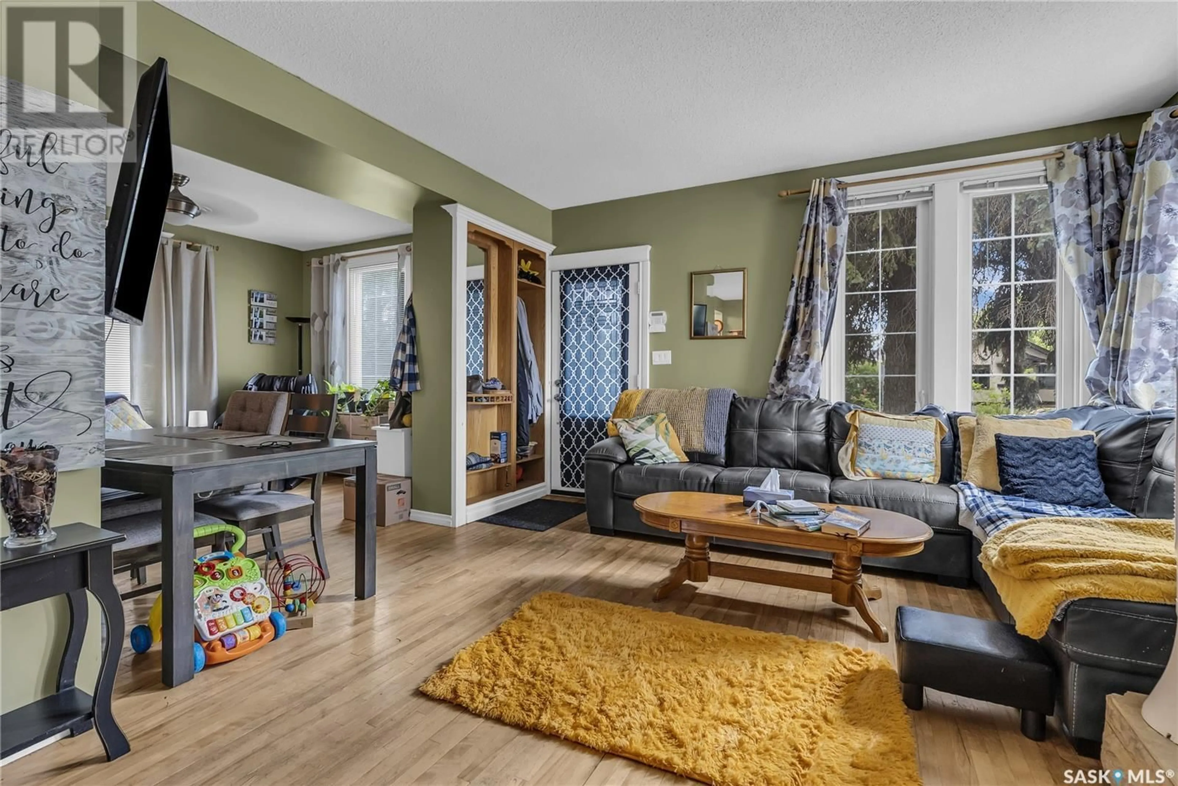 Living room with furniture, wood/laminate floor for 1121 B AVENUE, Saskatoon Saskatchewan S7L1G2